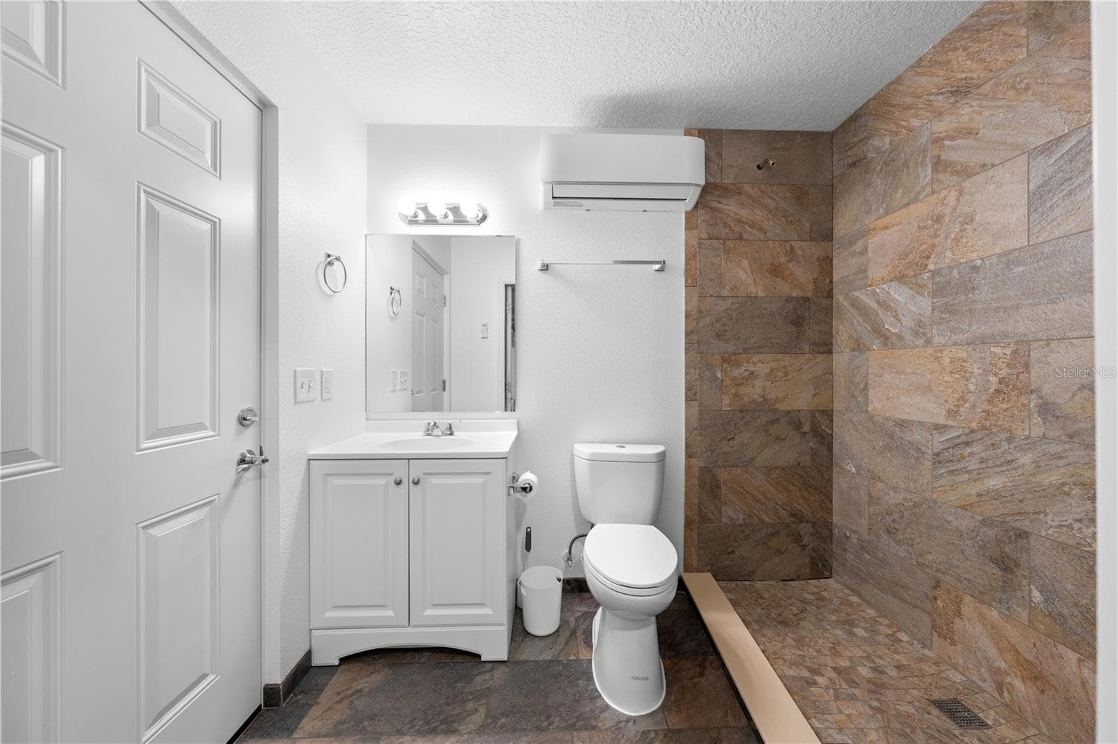 Inside of garage with bathroom, a/c, attic space, electric and water that is attached to the in-law suite bathroom. - 4055 EDSEL AVE, ST CLOUD