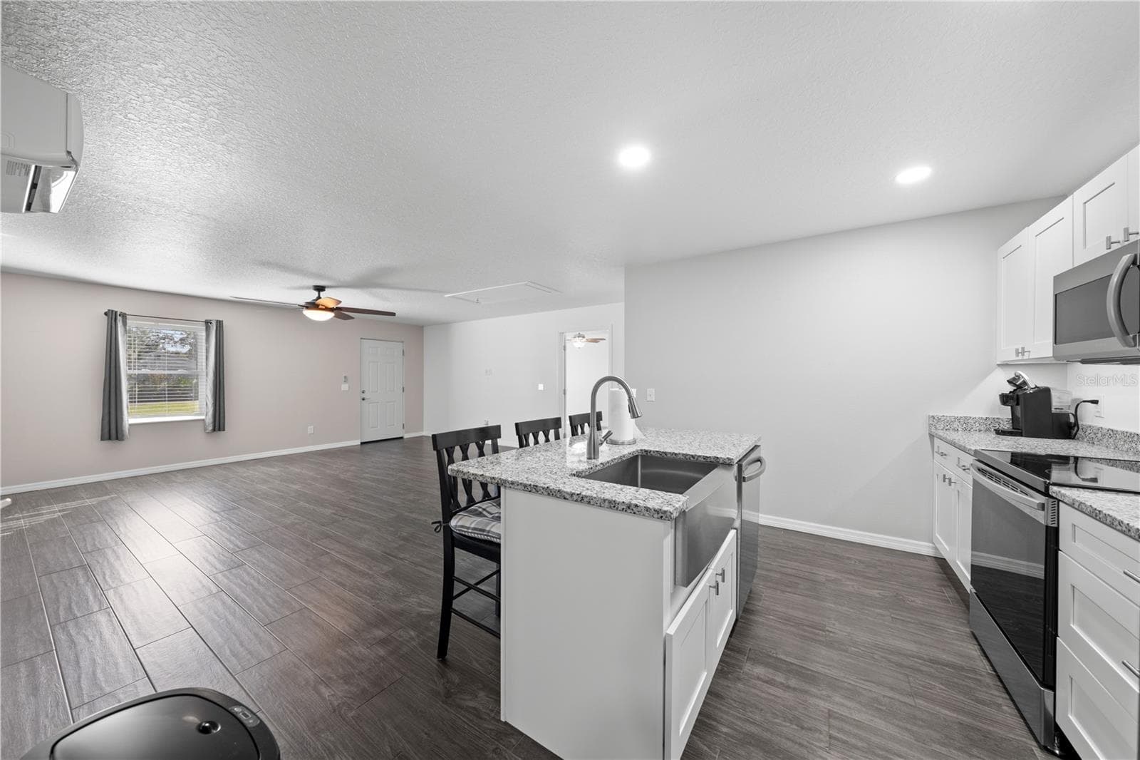 In-law suite kitchen island looking at the front door from the laundry room - 4055 EDSEL AVE, ST CLOUD