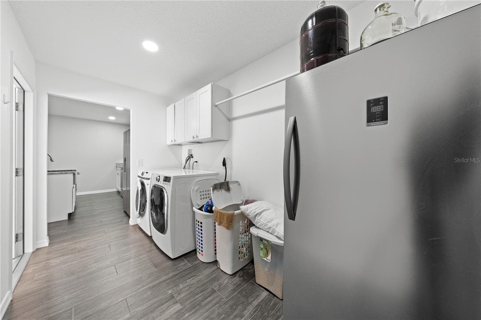 In-law suite laundry room going into the kitchen coming in from the garage door on the left. - 4055 EDSEL AVE, ST CLOUD