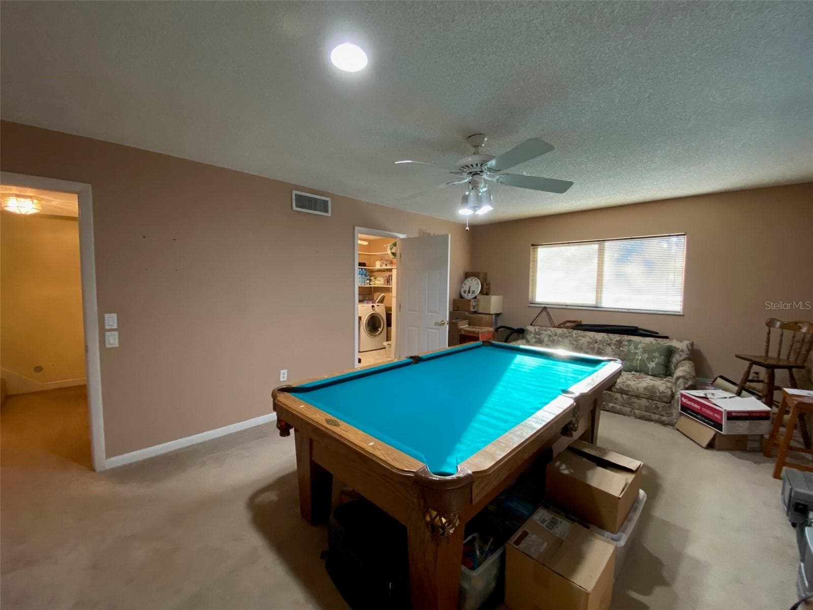 lower level family room measures 19'x13' and is just off of laundry room which measures 11'x9' and has shelving - 626 ORCHID LN, ALTAMONTE SPRINGS