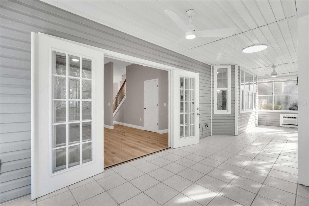 French doors allows the light to flood in from the sunporch - 2306 64TH ST W, BRADENTON