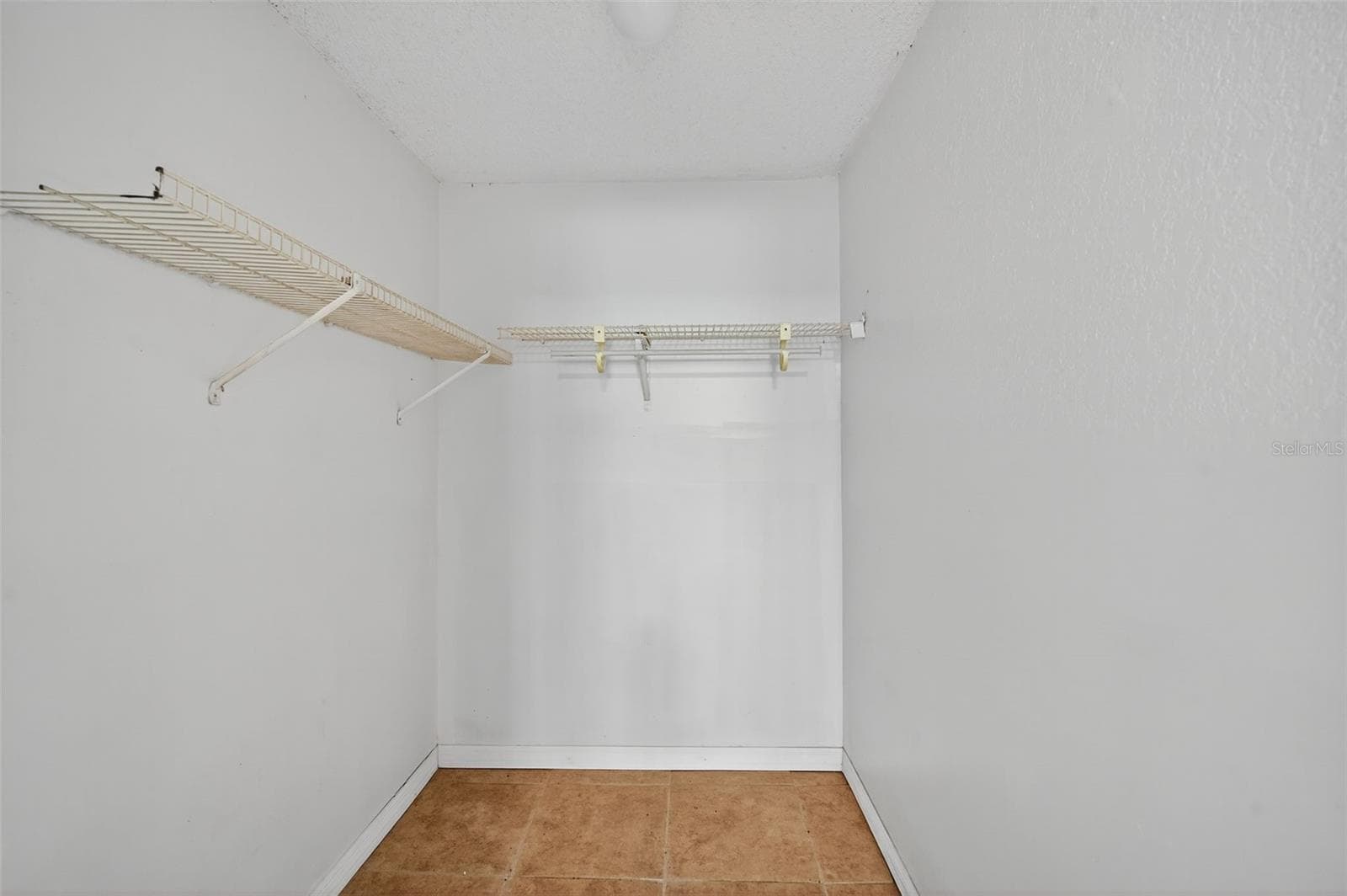 Walk-in closet of primary bedroom. - 6345 LOST TRL, HOLIDAY