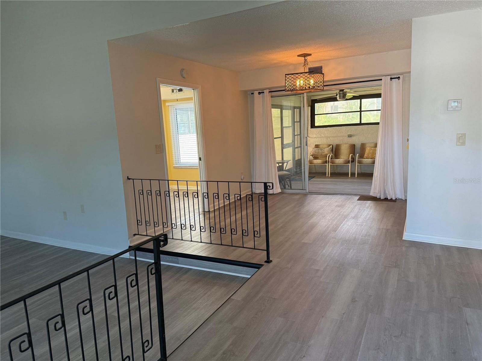 Entry foyer living room on the left, dining room, enclosed porch straight ahead, and the eat in kitchen to the left. - 2207 BELLEAIR RD #B22, CLEARWATER