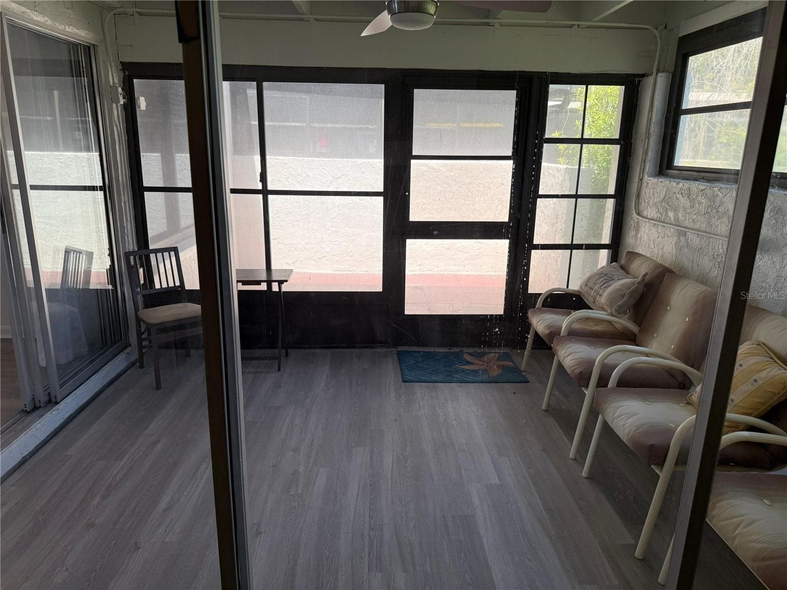 View from the primary bedroom to the Florida room opening to the Patio. - 2207 BELLEAIR RD #B22, CLEARWATER