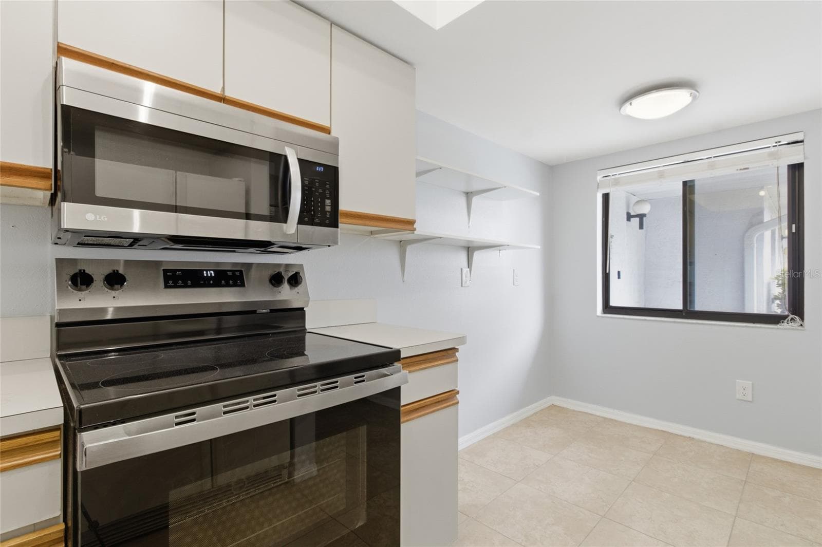 Kitchen with pantry - 2701 COUNTRYSIDE BLVD #102, CLEARWATER