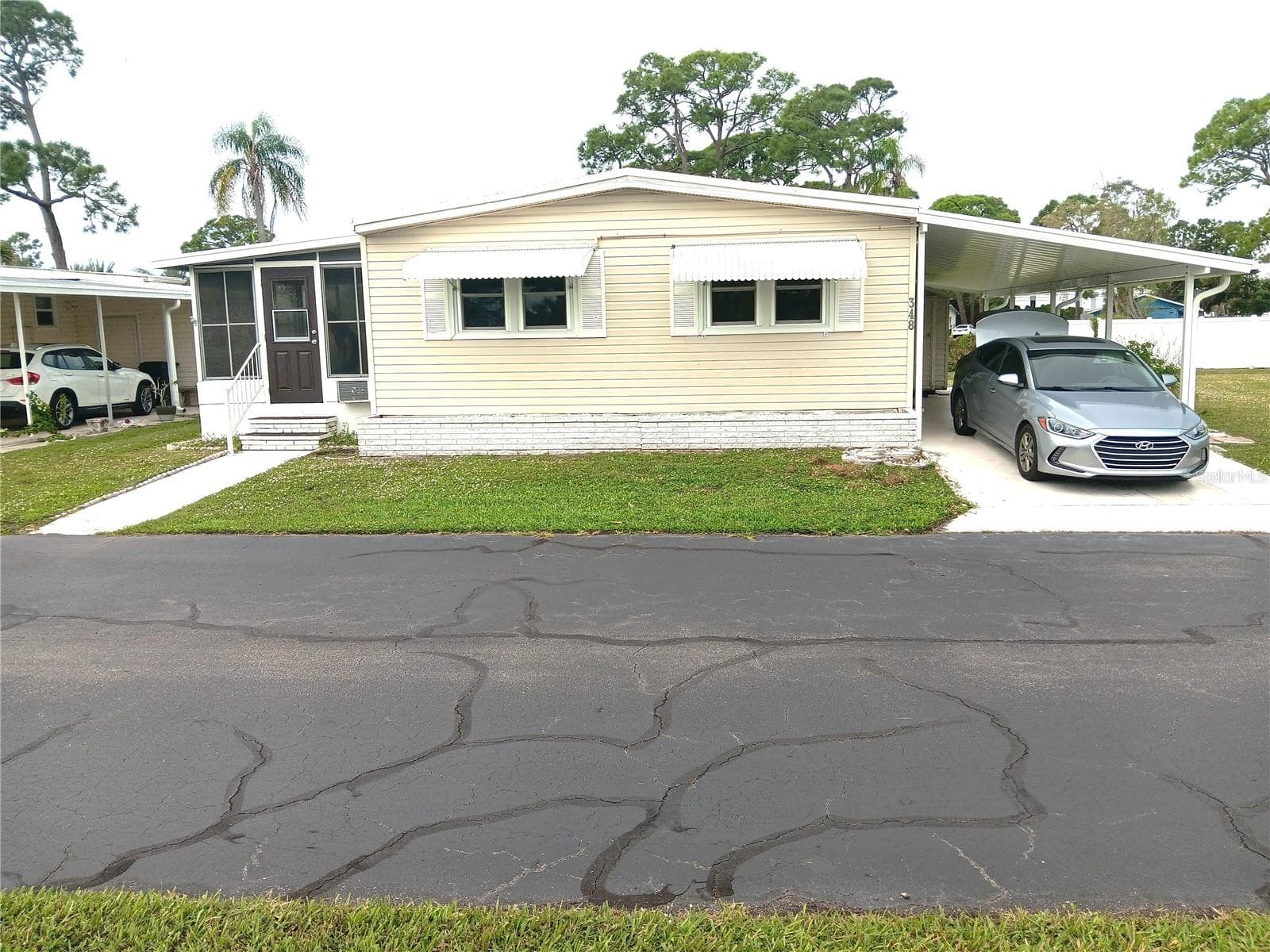 Notice 2 cars parked under 2-year-old car port.  New shed, too. - 348 TROPIC DR, OSPREY