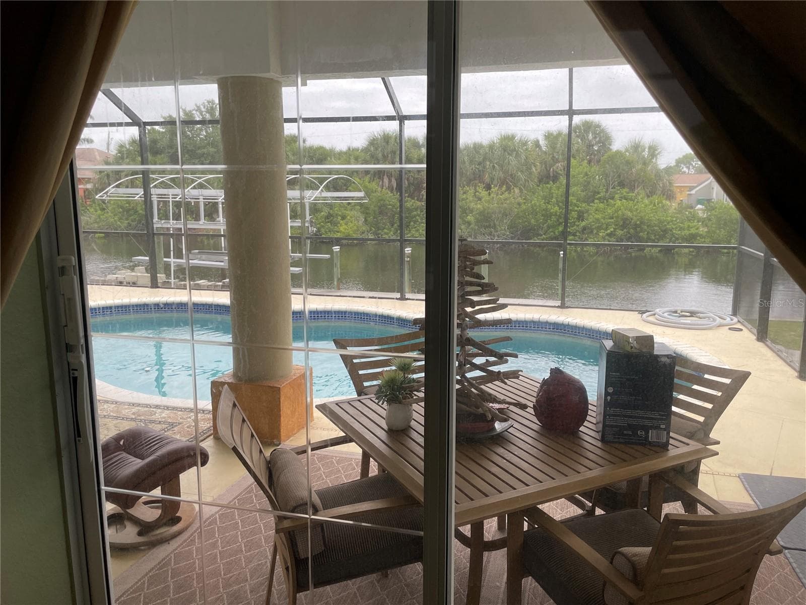 PRIMARY BEDROOM VIEW TO POOL LANAI - 18029 OHARA DR, PORT CHARLOTTE