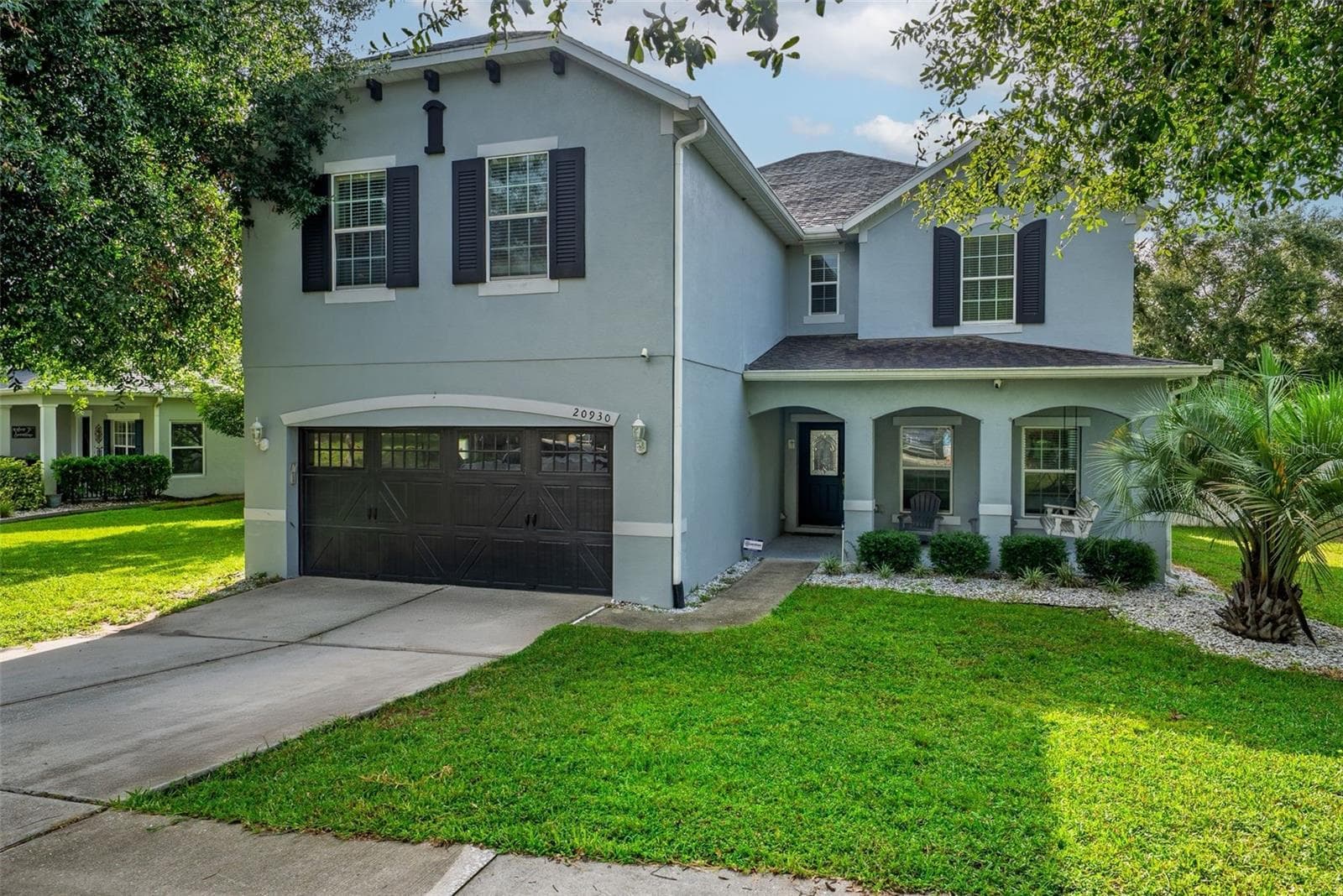 Shutters, garage door windows and beautiful trim makes this house standout - 20930 SULLIVAN RANCH BLVD, MOUNT DORA