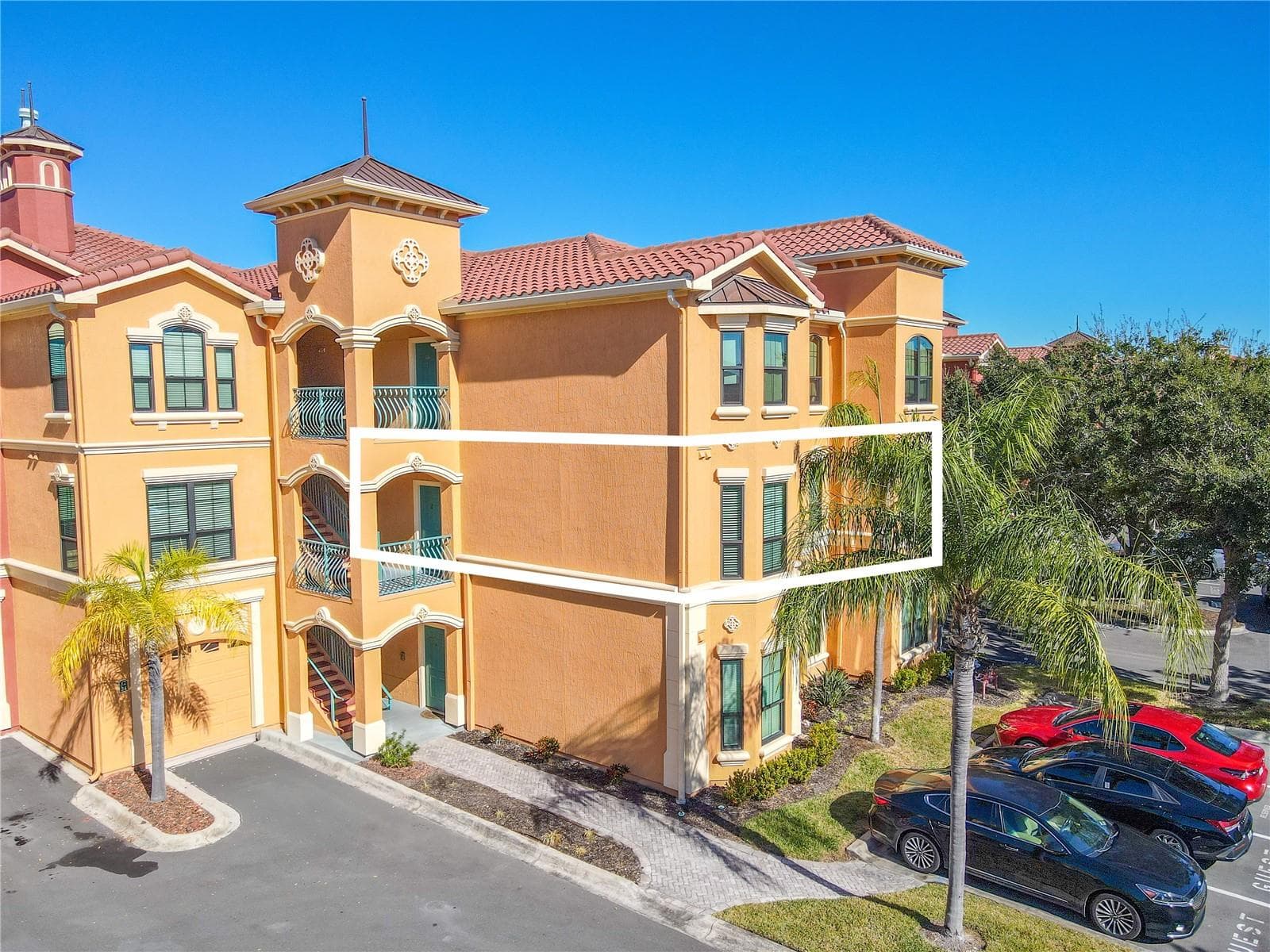 This second floor condo features open, light-filled living area features crown molding, laminate flooring, a modern ceiling fan, and a cozy gas fireplace, flowing seamlessly into the dining space for effortless everyday living and entertaining. - 2738 VIA TIVOLI #220B, CLEARWATER