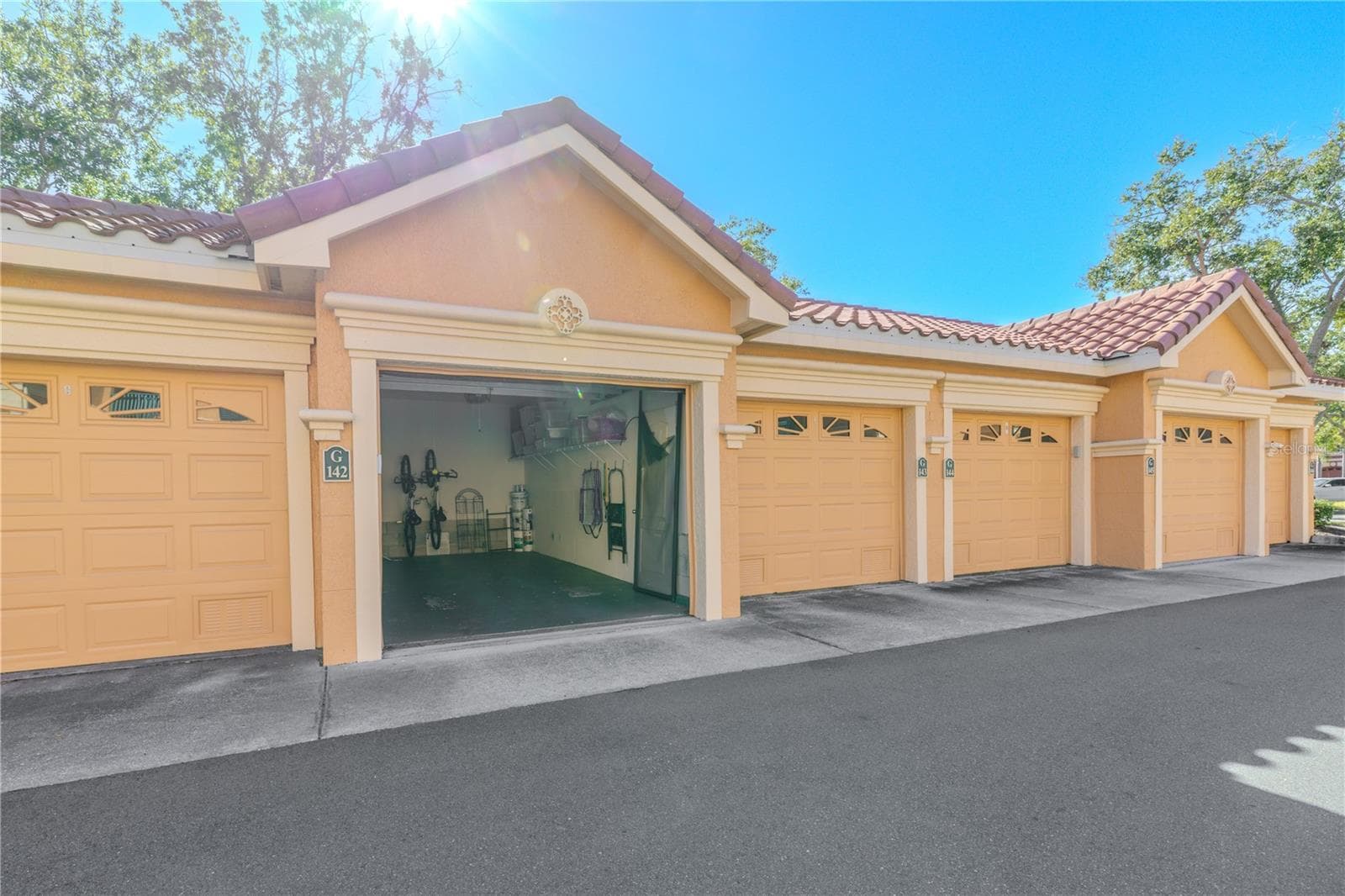 This private, ground-level garage offers secure parking and extra storage, conveniently located just steps from the unit within the beautifully maintained garage courtyard. - 2738 VIA TIVOLI #220B, CLEARWATER
