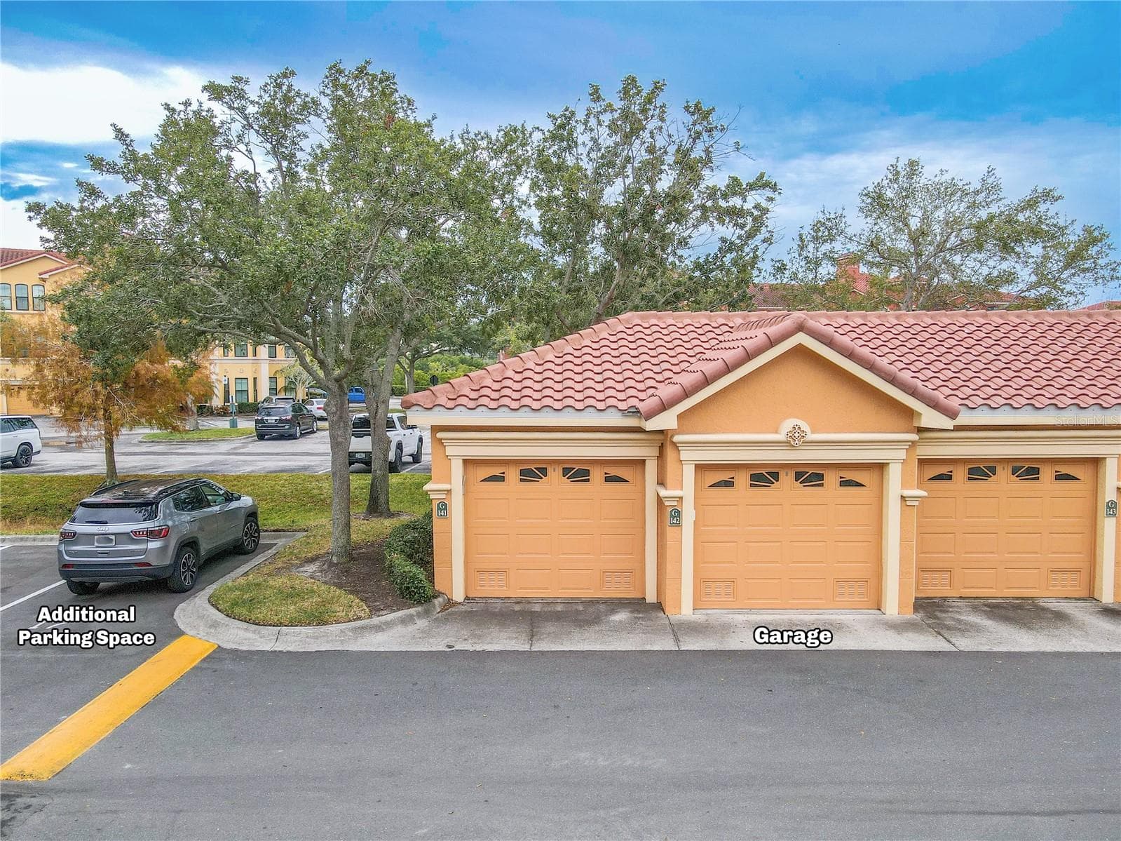Deeded private garage and 1 assigned parking spot, as noted in the photo, just across from the second floor condo unit. - 2738 VIA TIVOLI #220B, CLEARWATER
