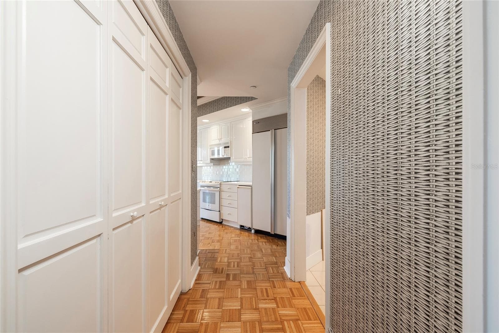 Kitchen Pantry on the left and Laundry Room entry on the right - 2 SEASIDE LN #103, BELLEAIR