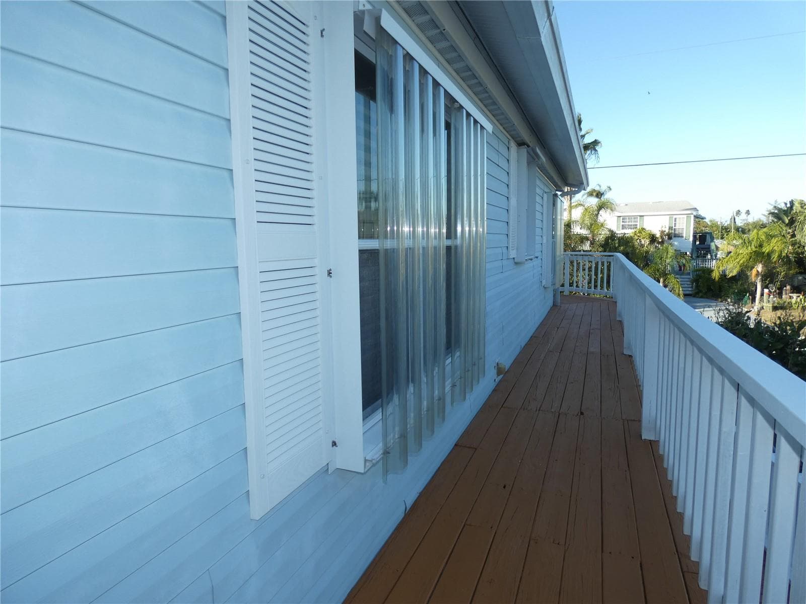 Storm shutters and side entrance. - 6814 GULL LN, HUDSON