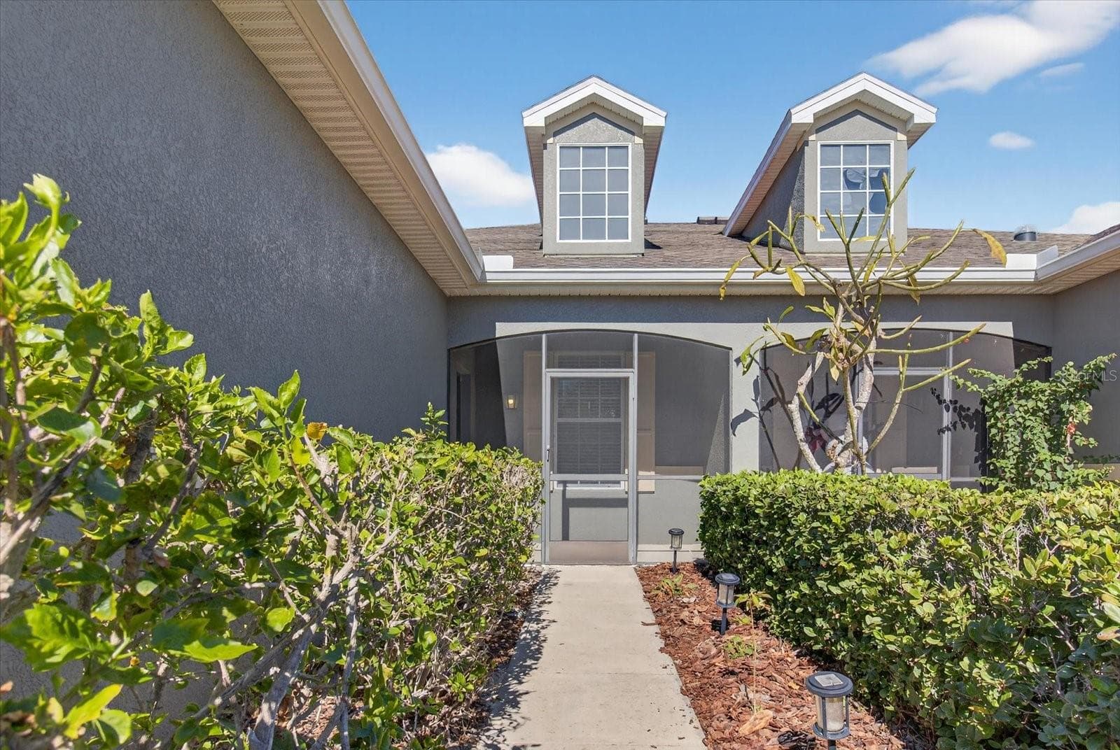 Welcoming front entrance with landscaped walkway. - 2153 BARRACUDA CT, HOLIDAY