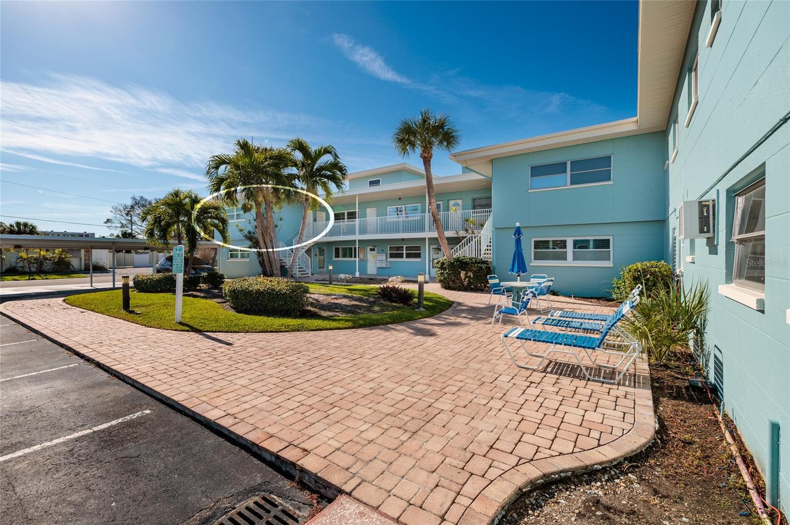 Unit 6 & courtyard. Laundry/storage room is to the right of the table w/umbrella. - 6000 2ND ST E #6, ST PETE BEACH