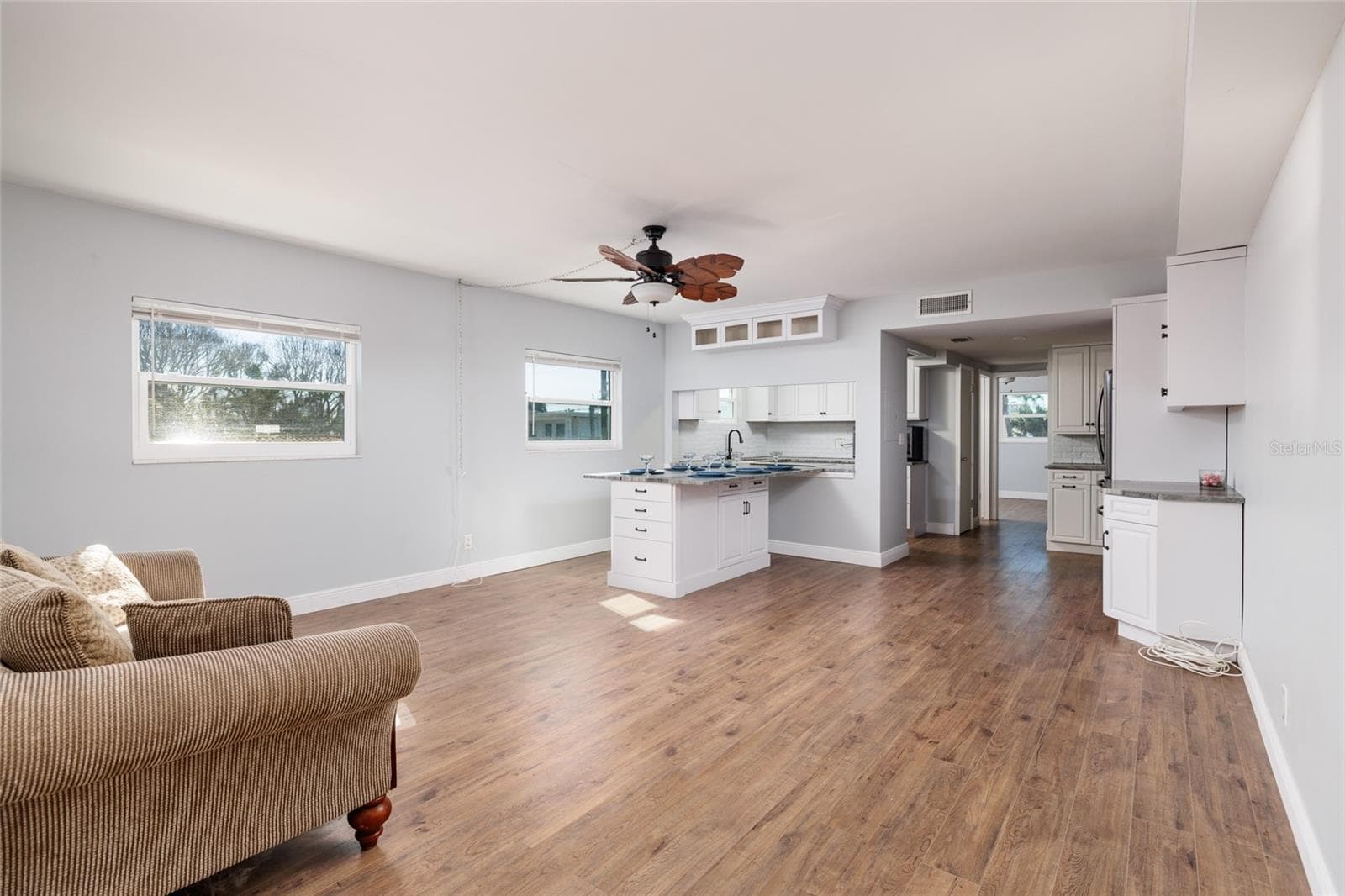 Living/Dining areas (16'x19'). Laminate flooring. Large pass through to kitchen. - 6000 2ND ST E #6, ST PETE BEACH