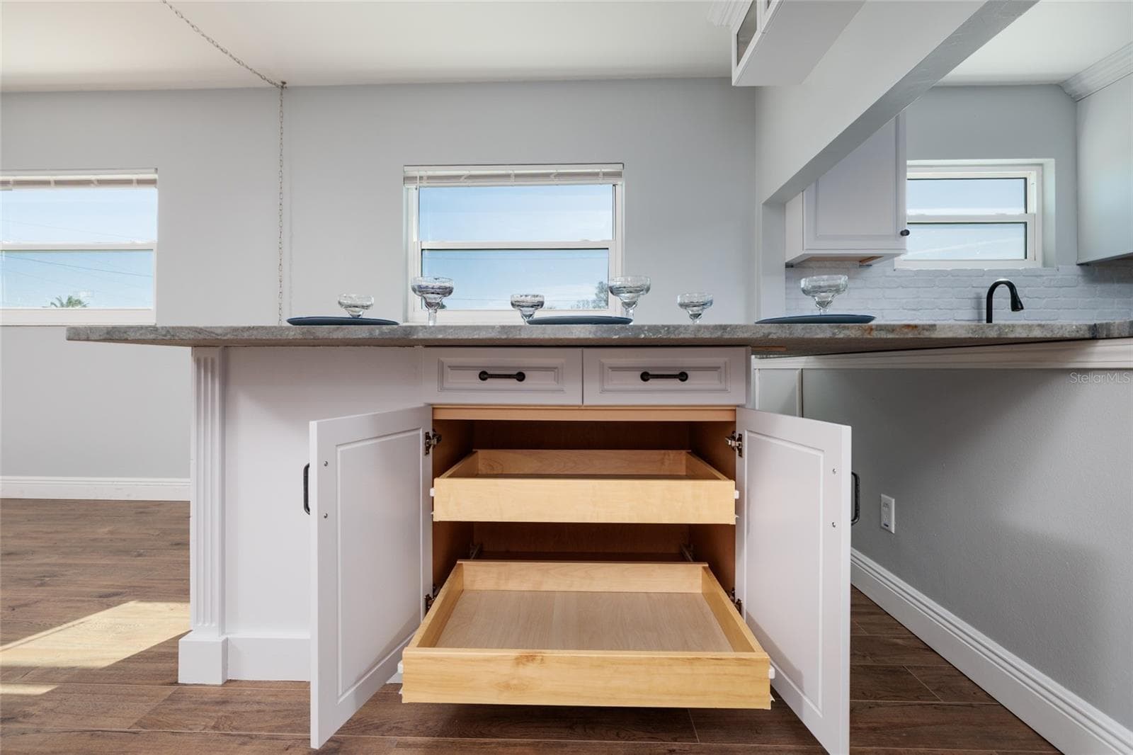 Pull out shelves below dining room granite table. - 6000 2ND ST E #6, ST PETE BEACH