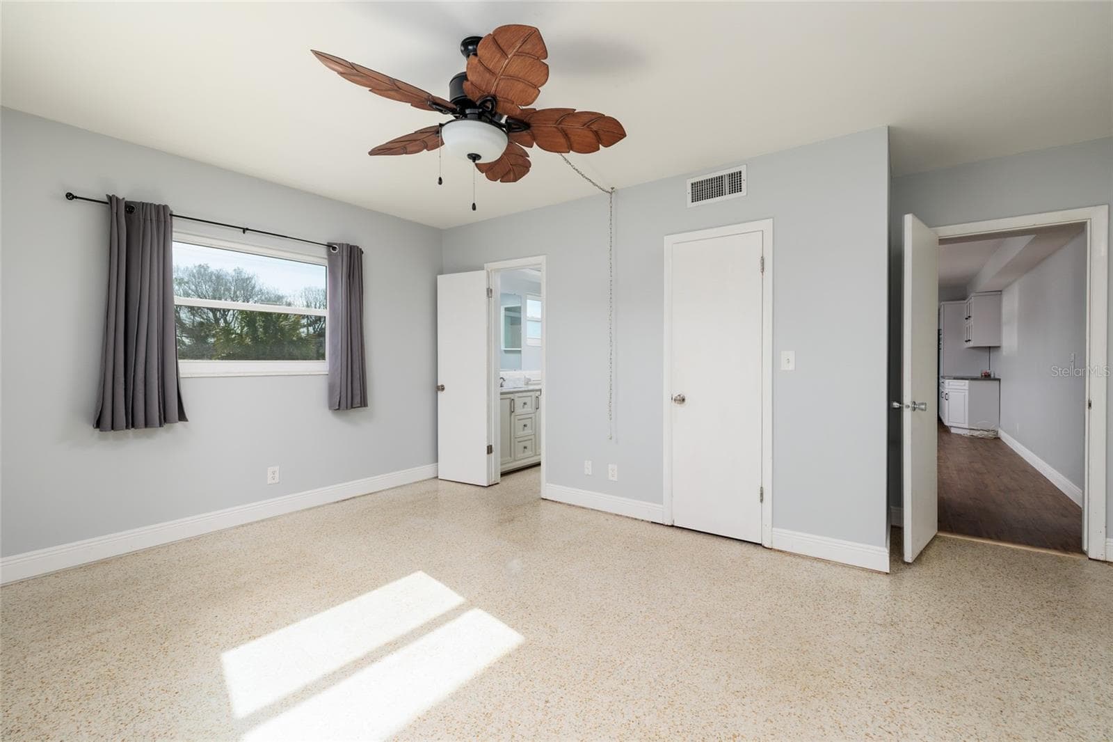 Primary bedroom. En-suite bath & closed door is walk-in closet. Doorway to living room. Private bedroom door to outside walkway/porch is out of pic on right. - 6000 2ND ST E #6, ST PETE BEACH