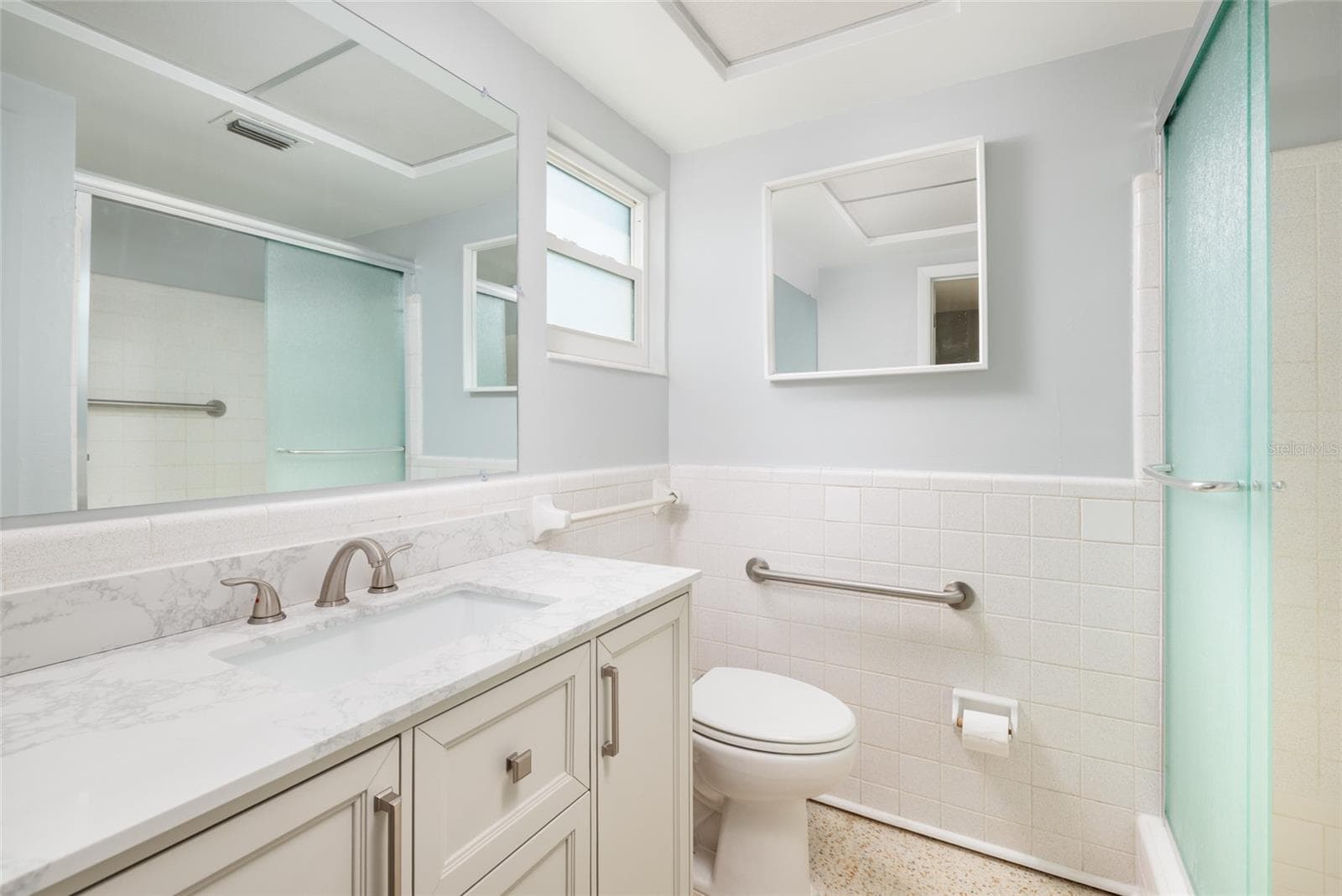 Primary bathroom w/Shower & linen closet. Granite counter. Hurricane impact double pane window. - 6000 2ND ST E #6, ST PETE BEACH