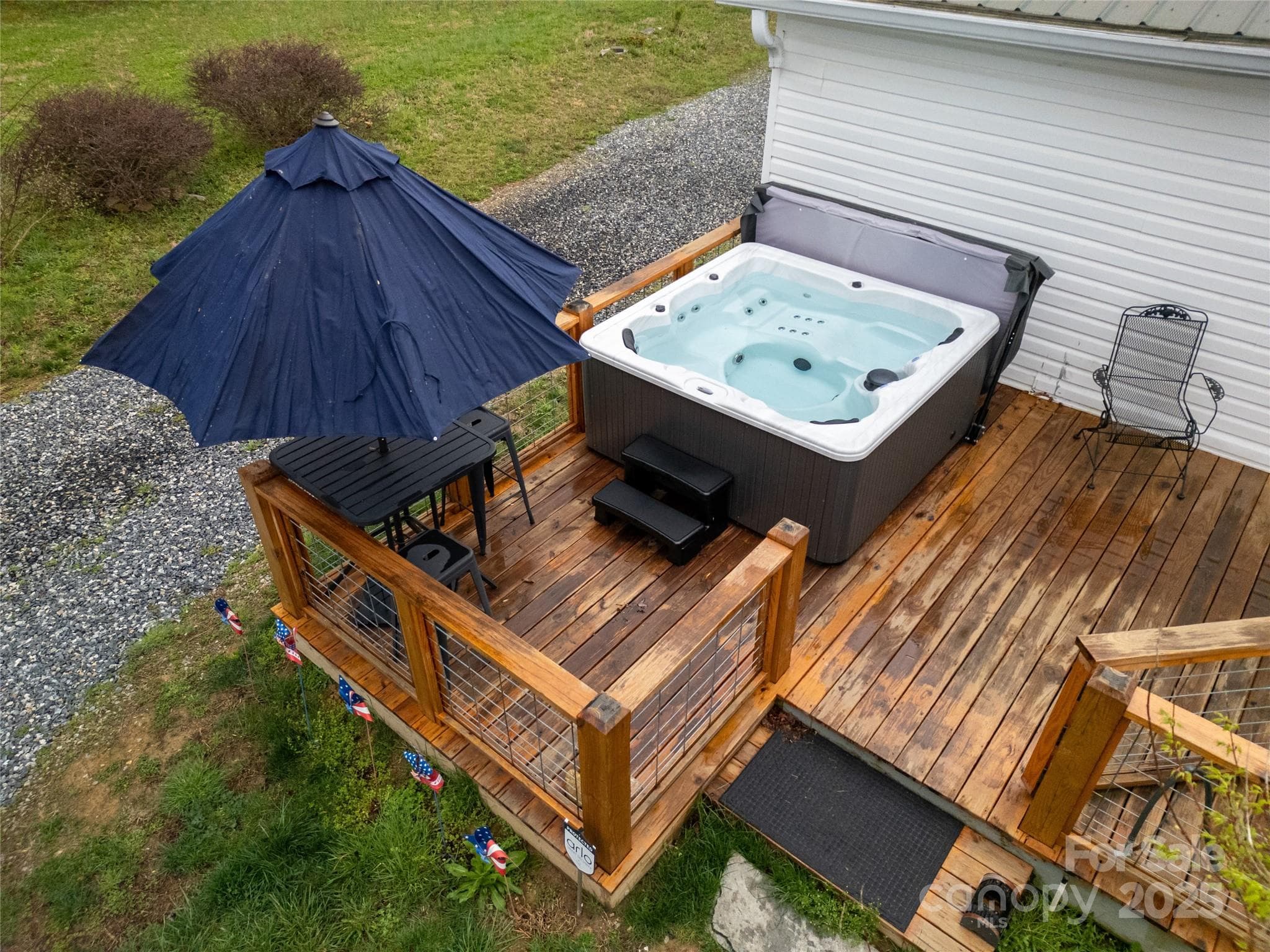 Rear Deck with the hot tub and high-top table on its left side. - 626 Fairview Loop, Hot Springs