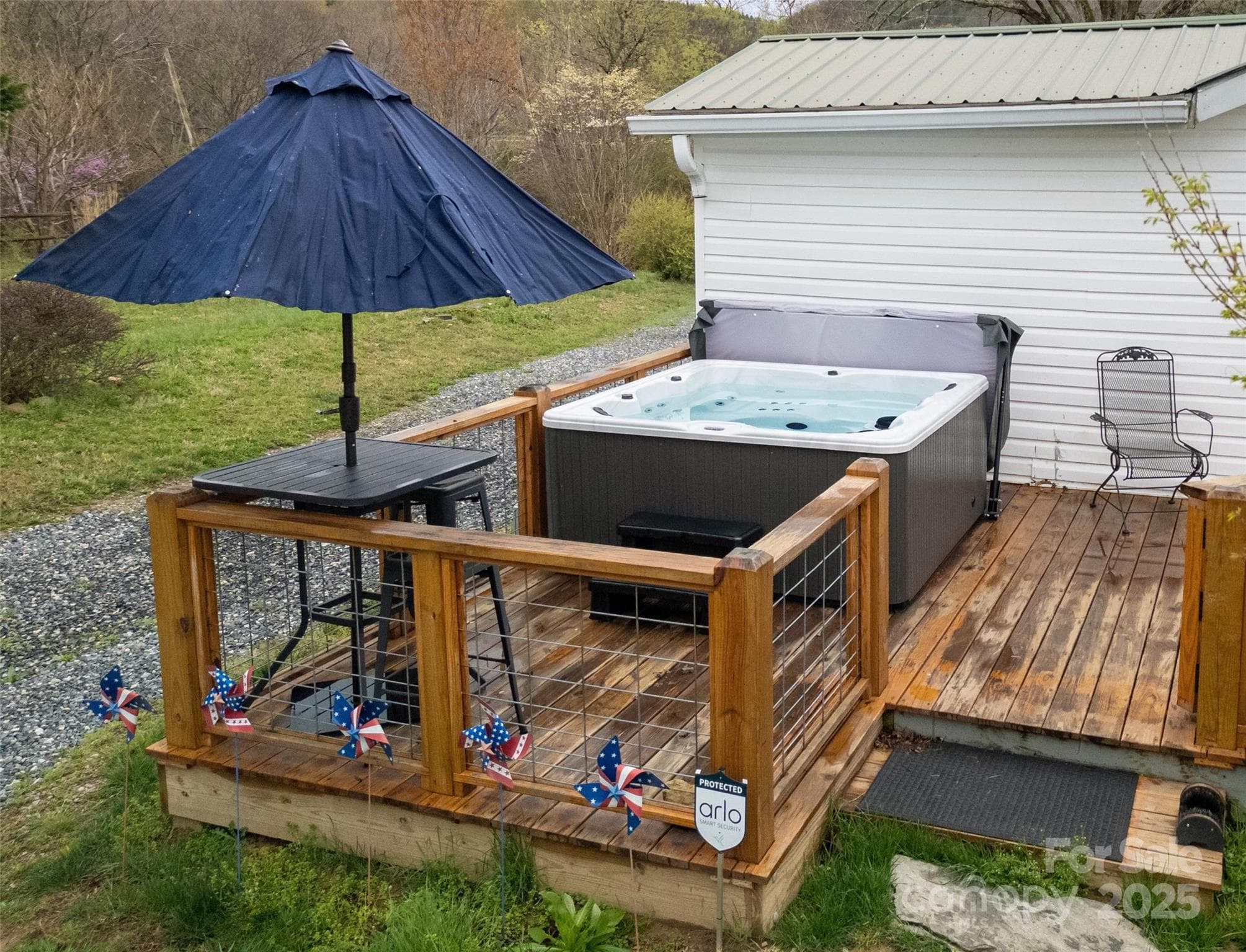 Rear Deck with the hot tub and high-top table on its left side. - 626 Fairview Loop, Hot Springs