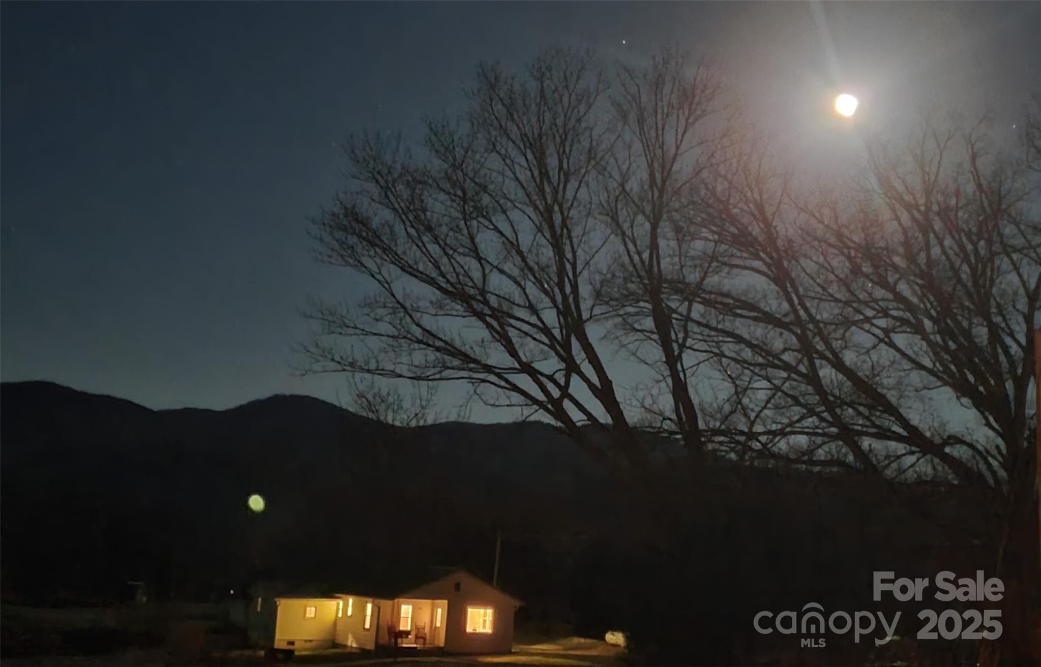 The house under a full moon in winter, with the mountain range to the east. - 626 Fairview Loop, Hot Springs