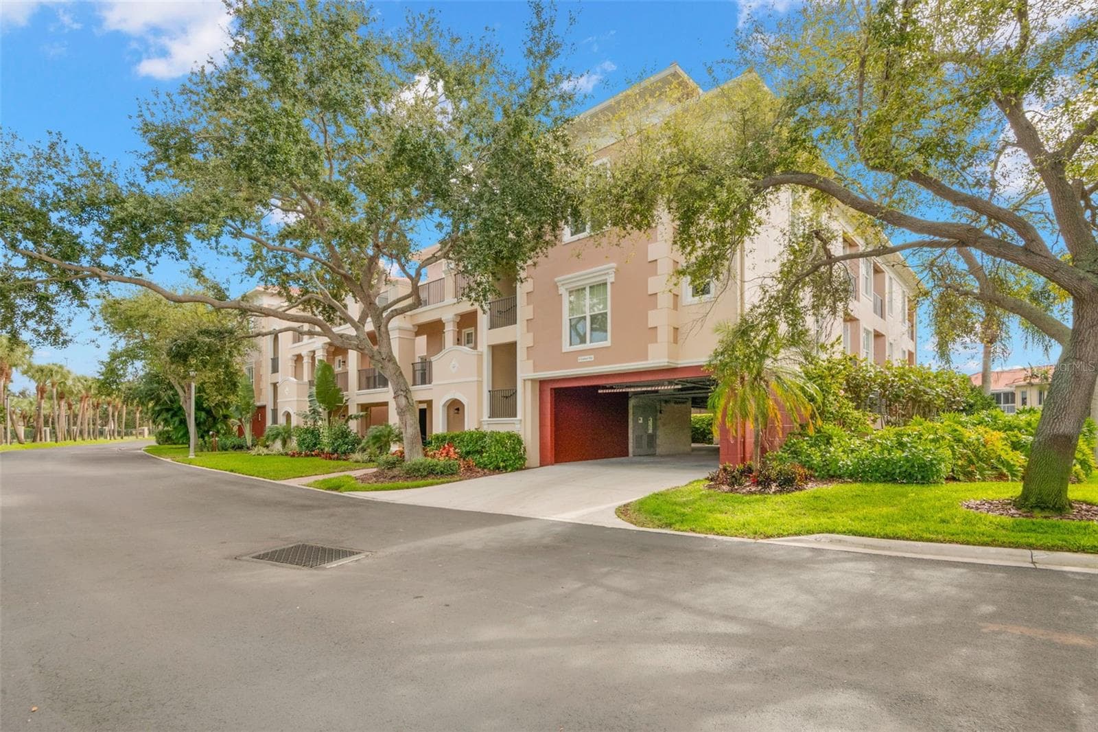 Front of building showing garage access where each of the 8-units in the building have two, deeded parking spaces that are well protected from the sun and weather elements. - 8 ACADEMY WAY S #123, ST PETERSBURG