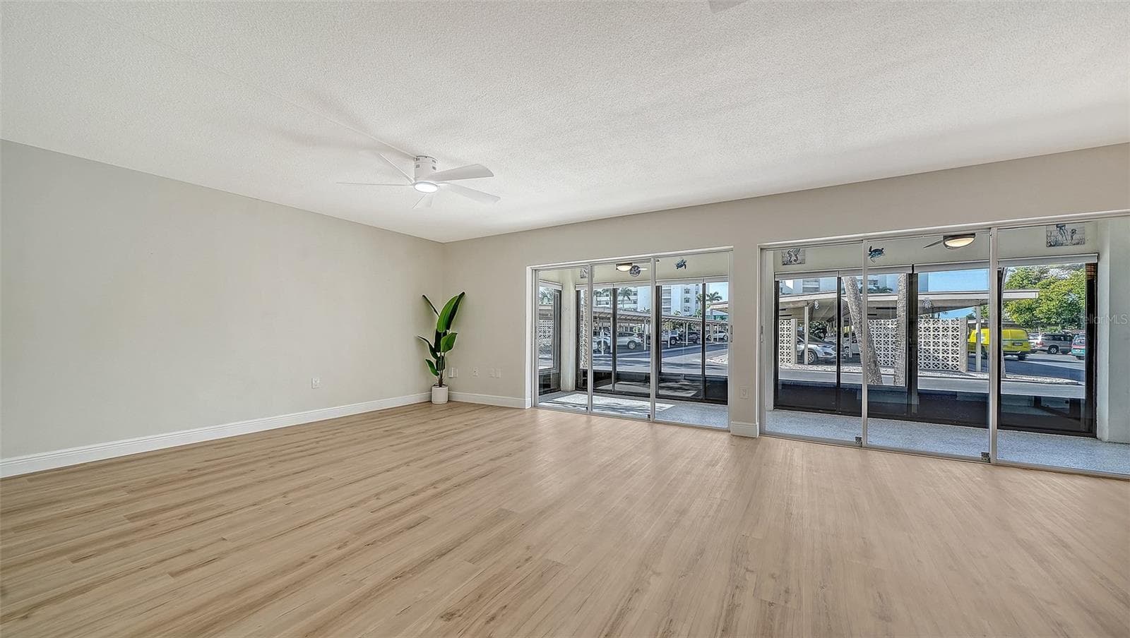 Living Room with 2 sets of sliders leading to the first of two lanais. - 101 WHISPERING SANDS DR #107, SARASOTA