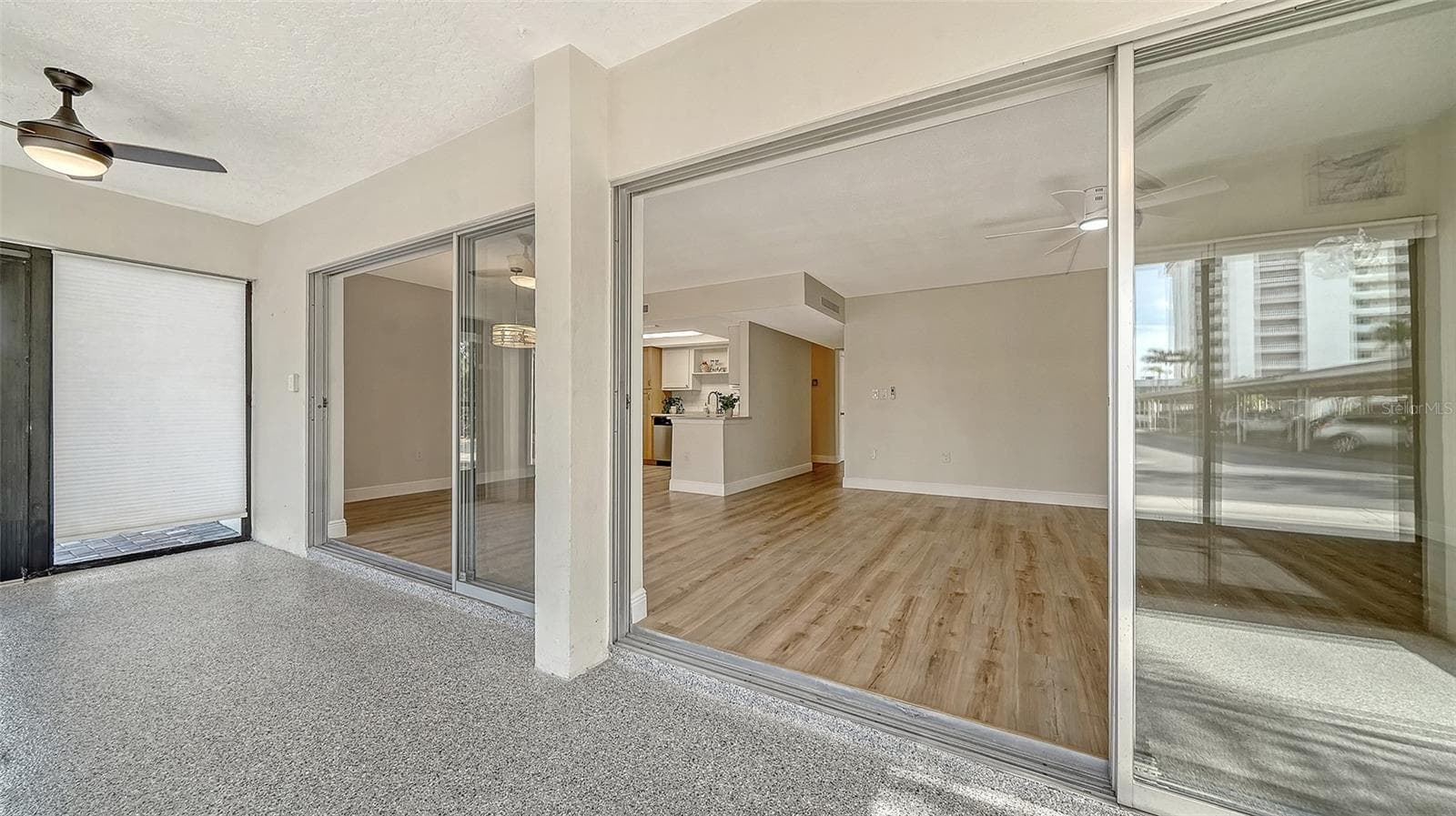 Looking back through the sliders into the Living and Dining Rooms. - 101 WHISPERING SANDS DR #107, SARASOTA