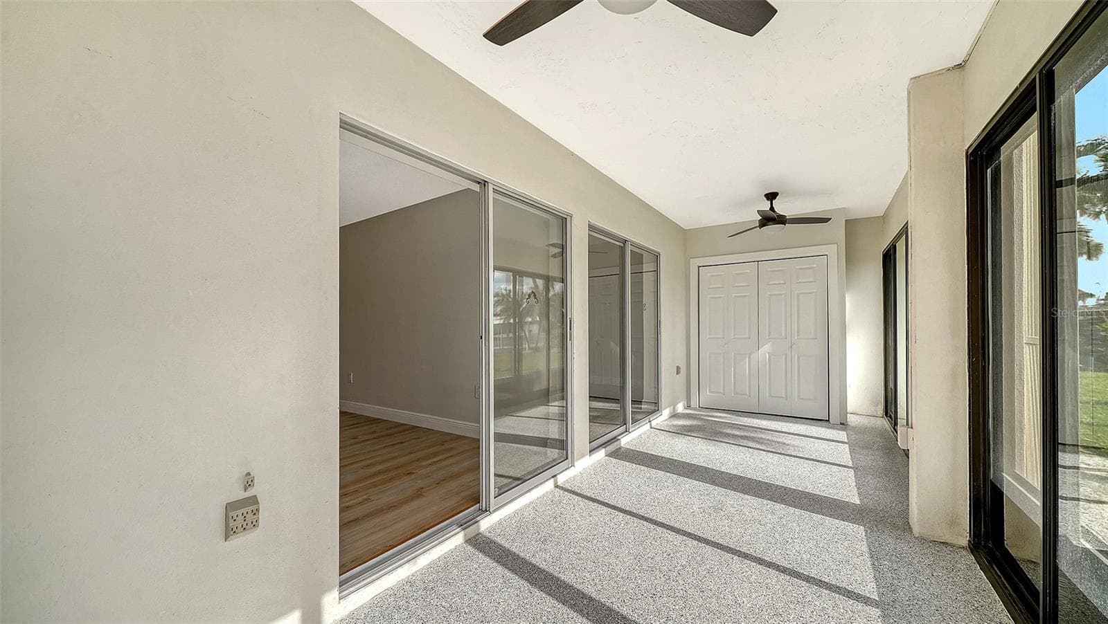 The sliders leading from the Primary Bedroom into the 2nd of two lanais. - 101 WHISPERING SANDS DR #107, SARASOTA