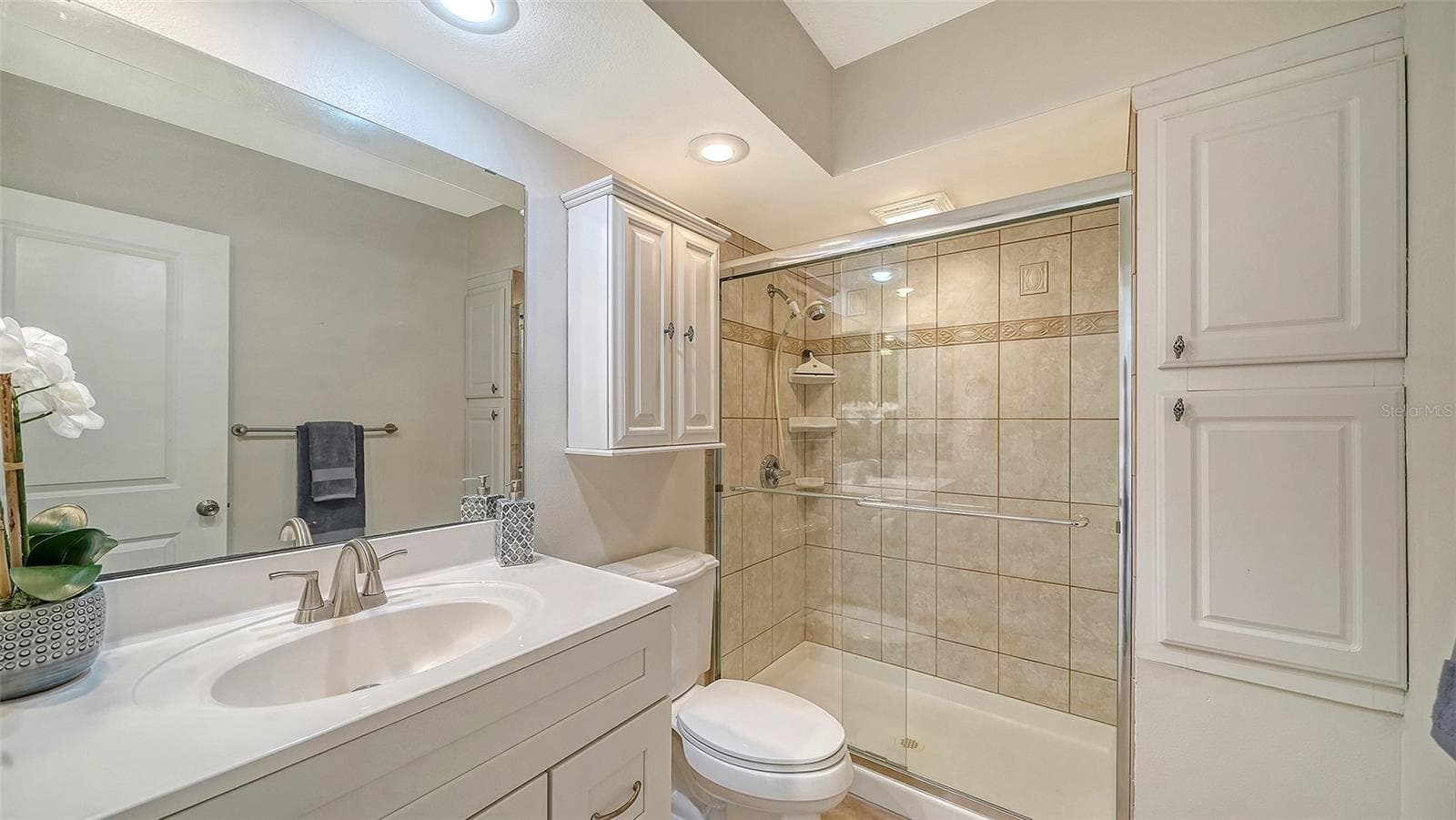 Primary Bathroom with granite counters and walk-in shower. - 101 WHISPERING SANDS DR #107, SARASOTA