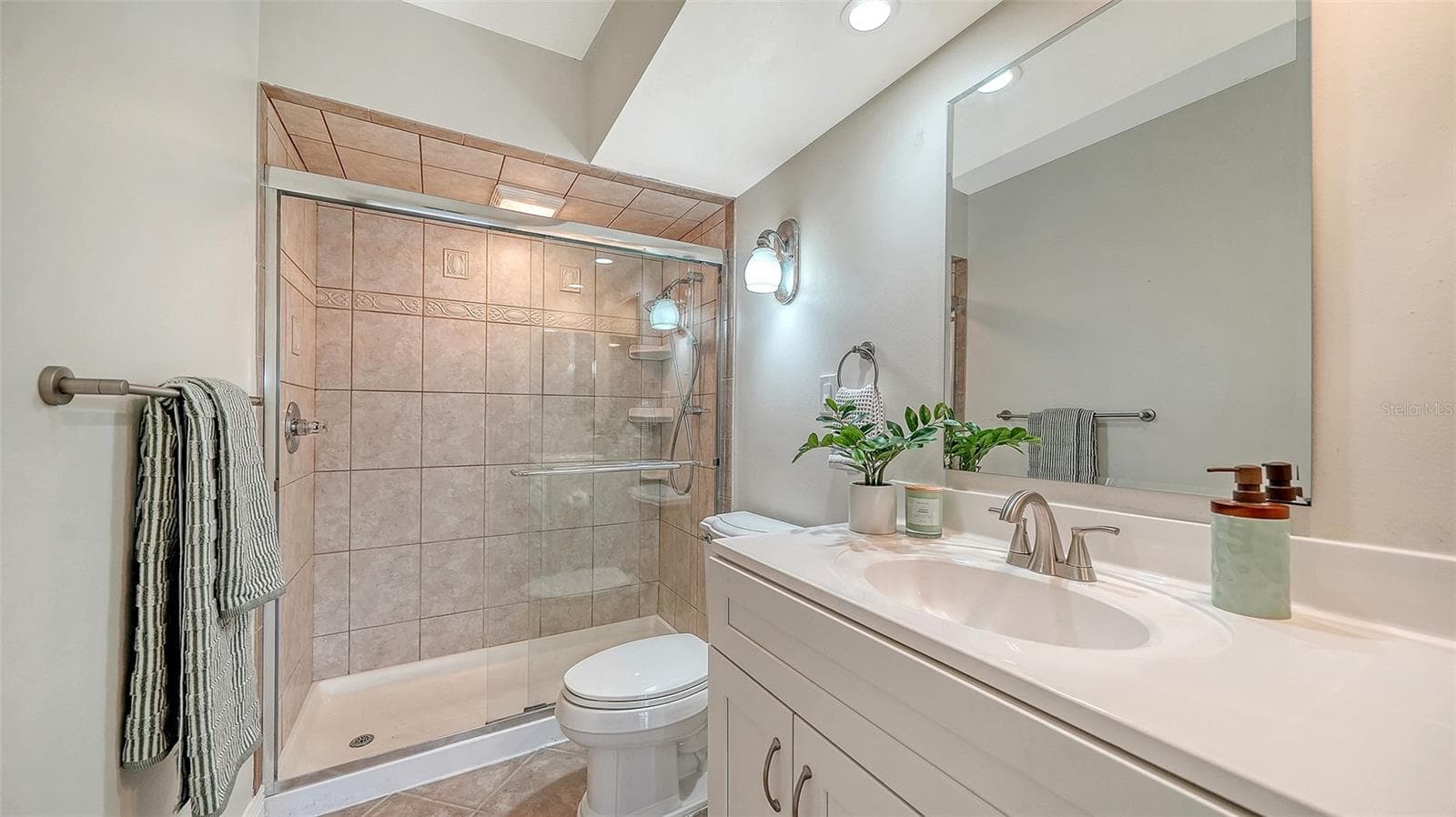 Guest Bathroom, also with granite countertop and glassed walk-in shower. - 101 WHISPERING SANDS DR #107, SARASOTA