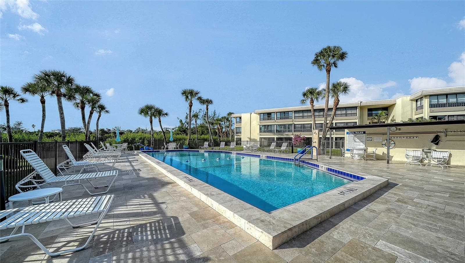 Clubhouse pool with new travertine tile deck. - 101 WHISPERING SANDS DR #107, SARASOTA