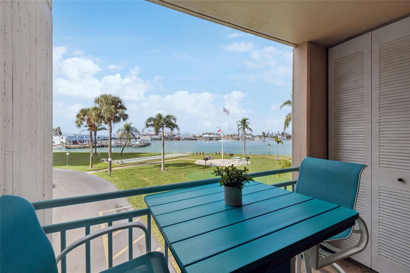 Balcony off the kitchen. Gorgeous view of John's Pass! - 1 KEY CAPRI #101E, TREASURE ISLAND