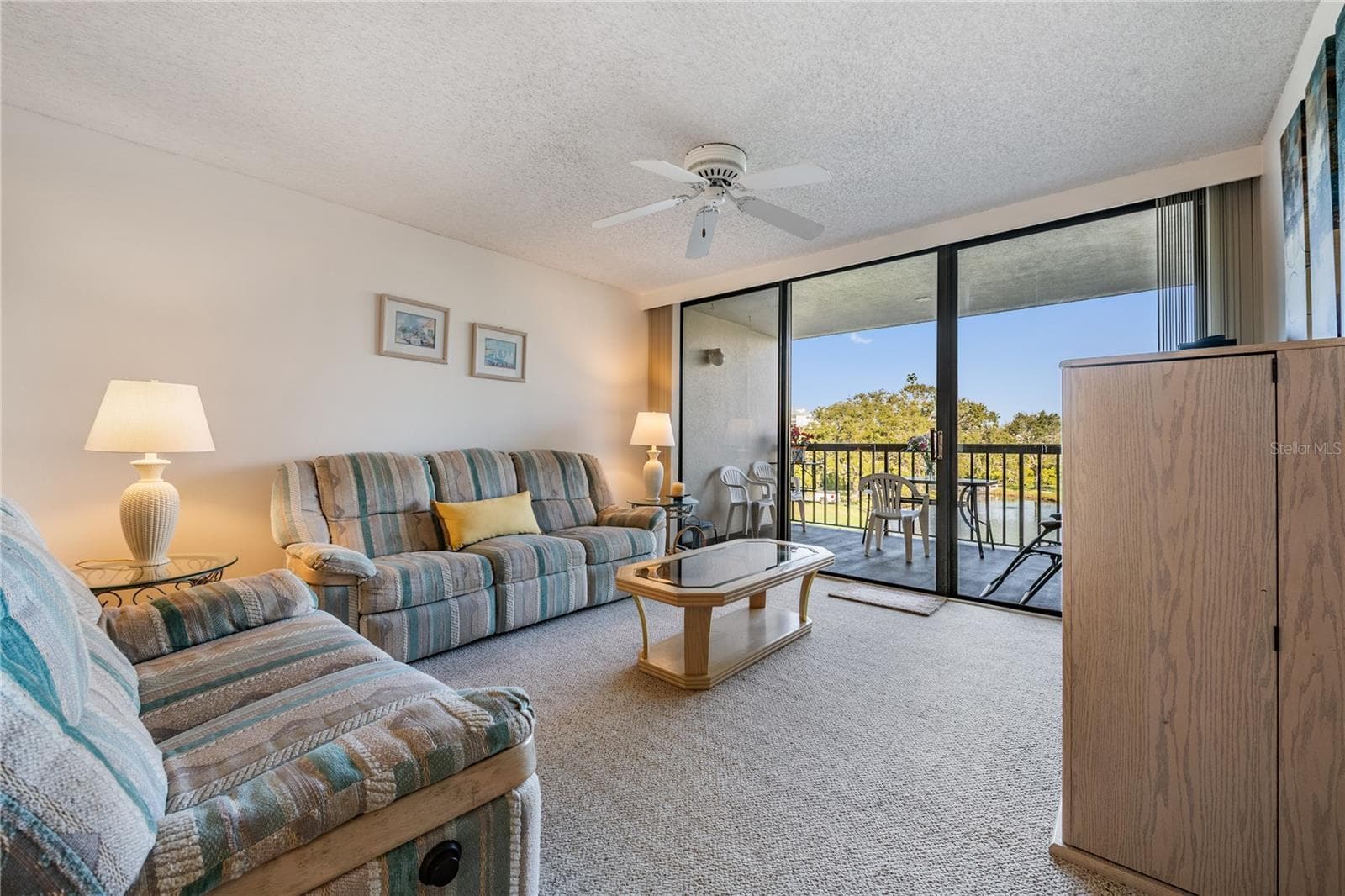 Living area with sliders to the balcony - 11590 SHIPWATCH DR #347, LARGO