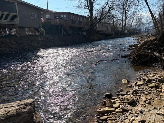 back side of home as seen from across the creek - 129 Mallard Loop, Waynesville