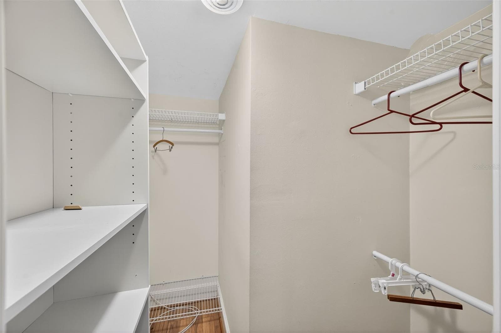 Primary bedroom walk in closet with built in's - 131 BLUFF VIEW DR #403, BELLEAIR BLUFFS