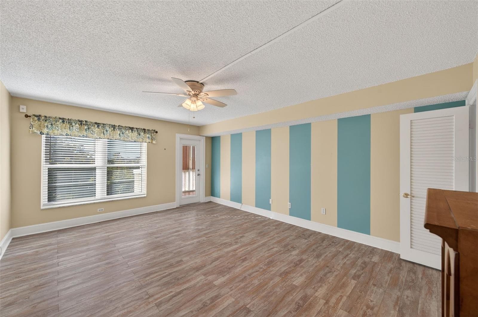 Bedroom 3 with entry to the Florida Room can double as an office or den. - 131 BLUFF VIEW DR #403, BELLEAIR BLUFFS
