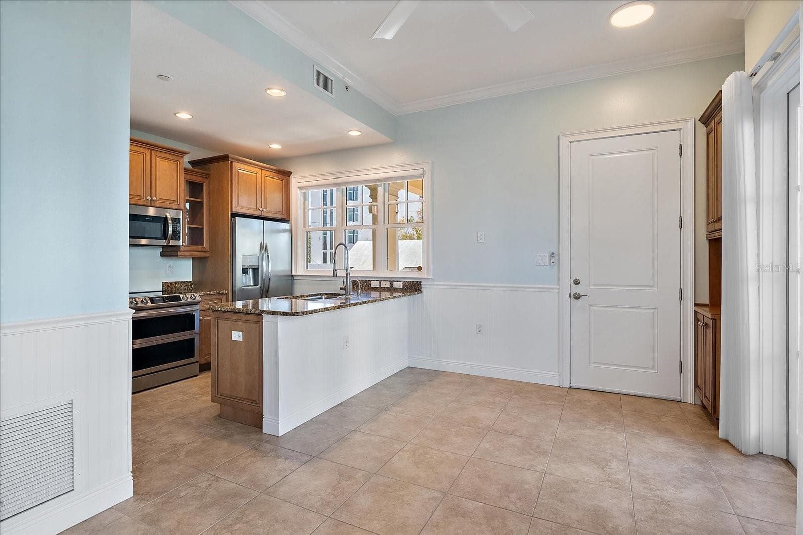 Open living area with seamless flow to kitchen - 445 N ORANGE AVE #210, SARASOTA