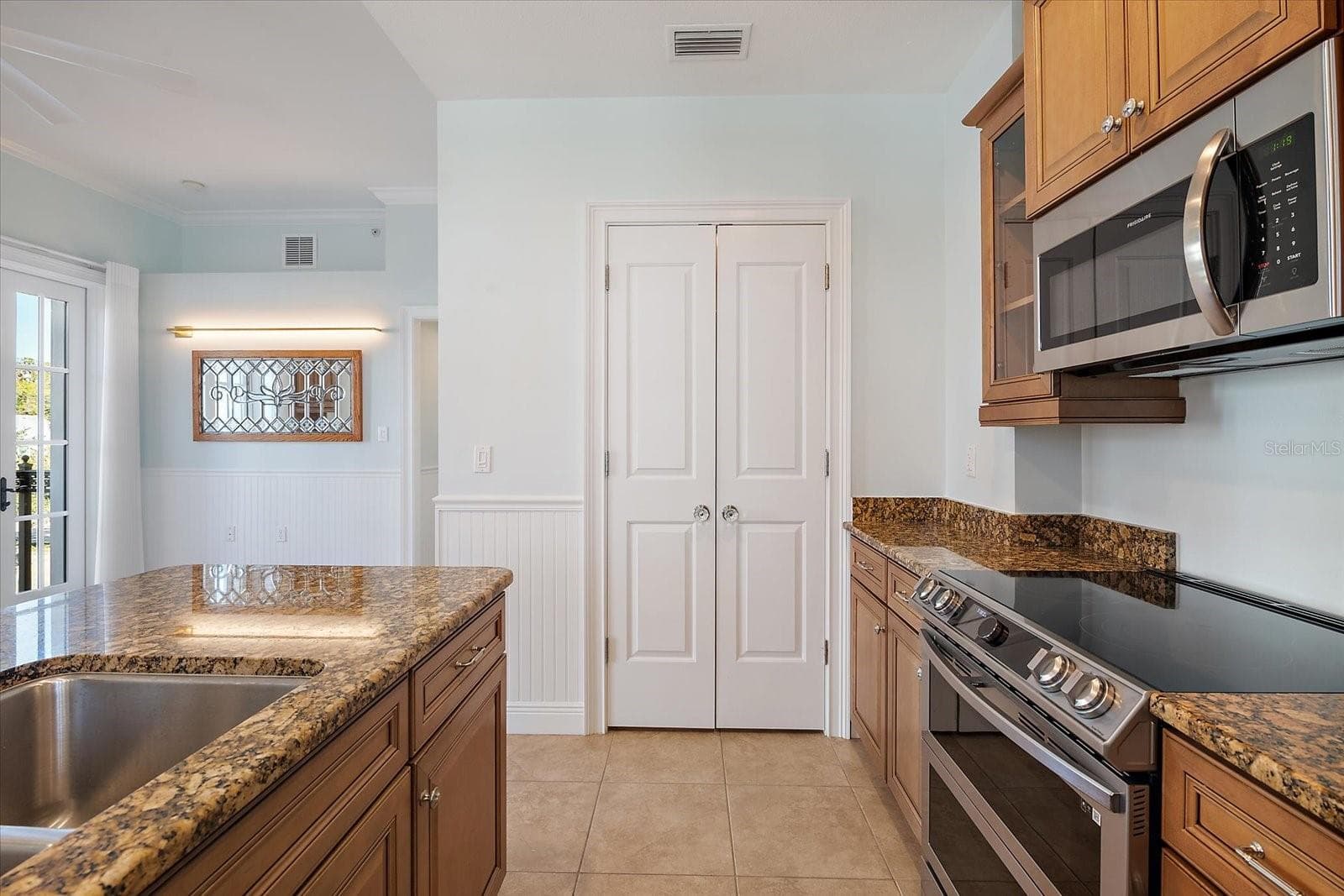 Kitchen with ample cabinetry and stainless appliances - 445 N ORANGE AVE #210, SARASOTA