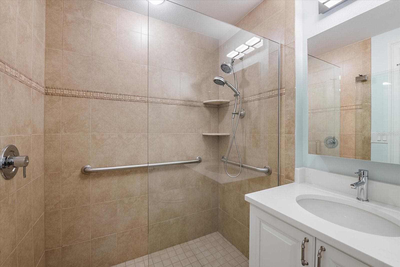 Bathroom with walk-in shower and updated vanity - 445 N ORANGE AVE #210, SARASOTA
