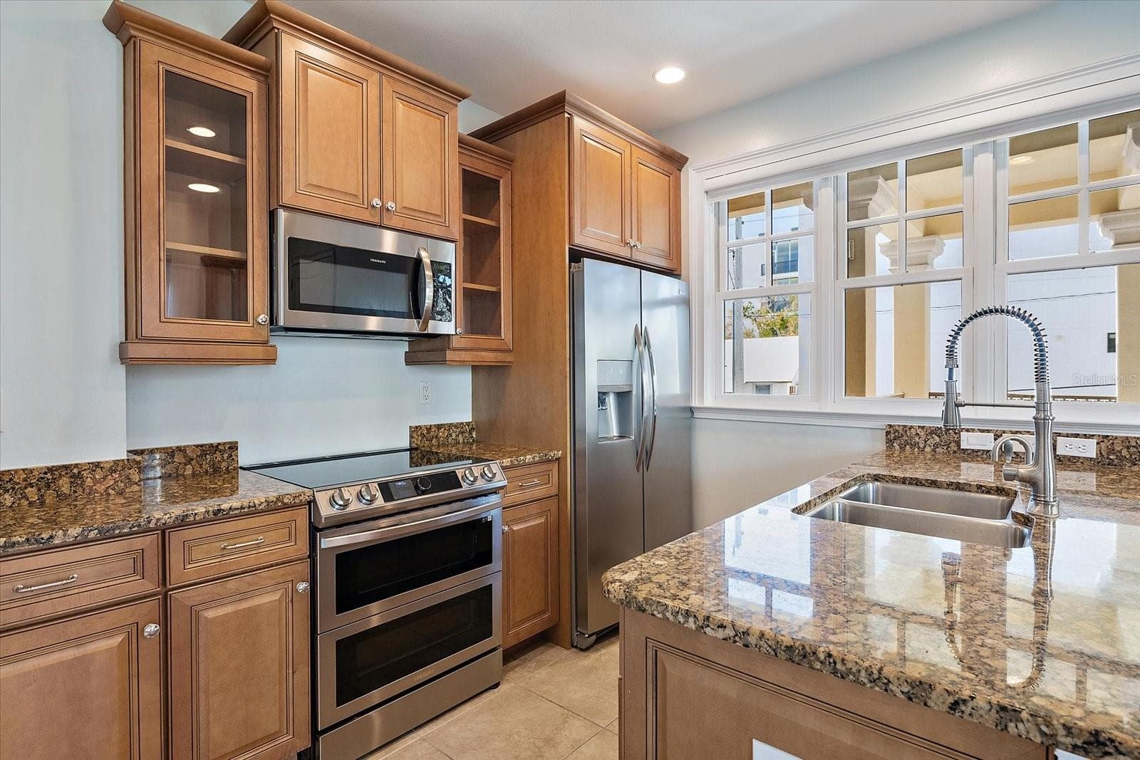 Kitchen with granite countertops and wood cabinetry - 445 N ORANGE AVE #210, SARASOTA