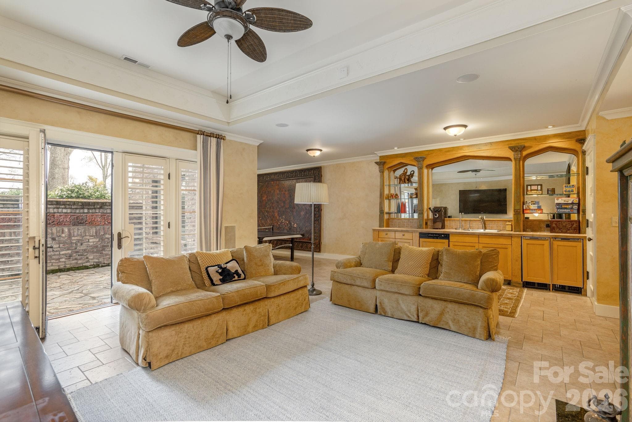 Large windows and French doors connect the lower level to the outdoors - 8 Fairway Place, Asheville