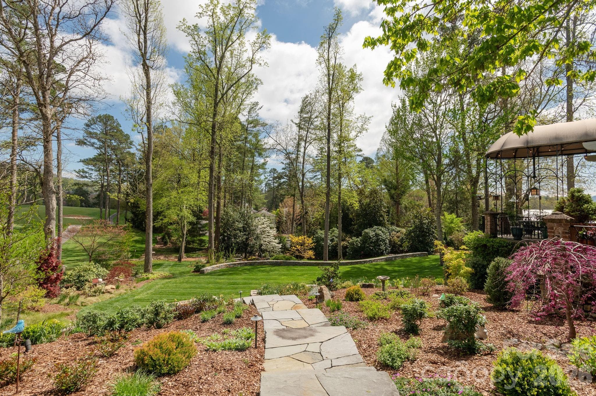 Winding stone pathways connect the gardens and outdoor living spaces - 8 Fairway Place, Asheville
