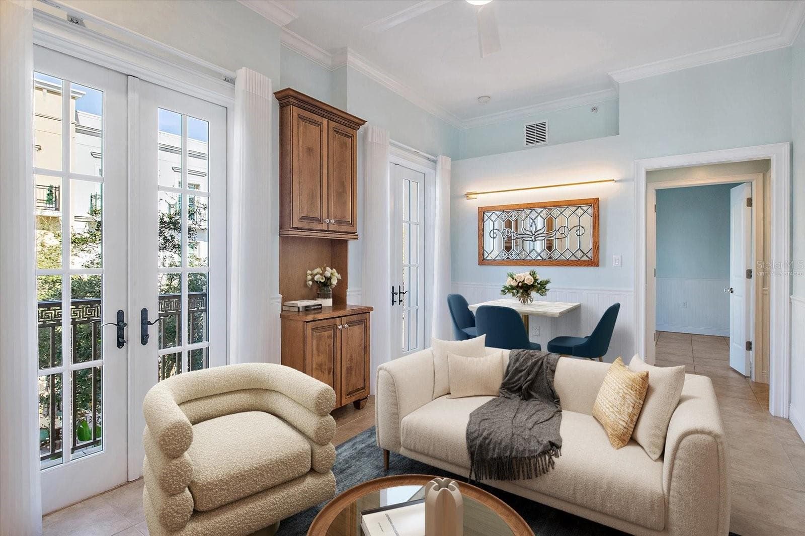 Virtually staged -Living room with natural light and courtyard views - 445 N ORANGE AVE #210, SARASOTA