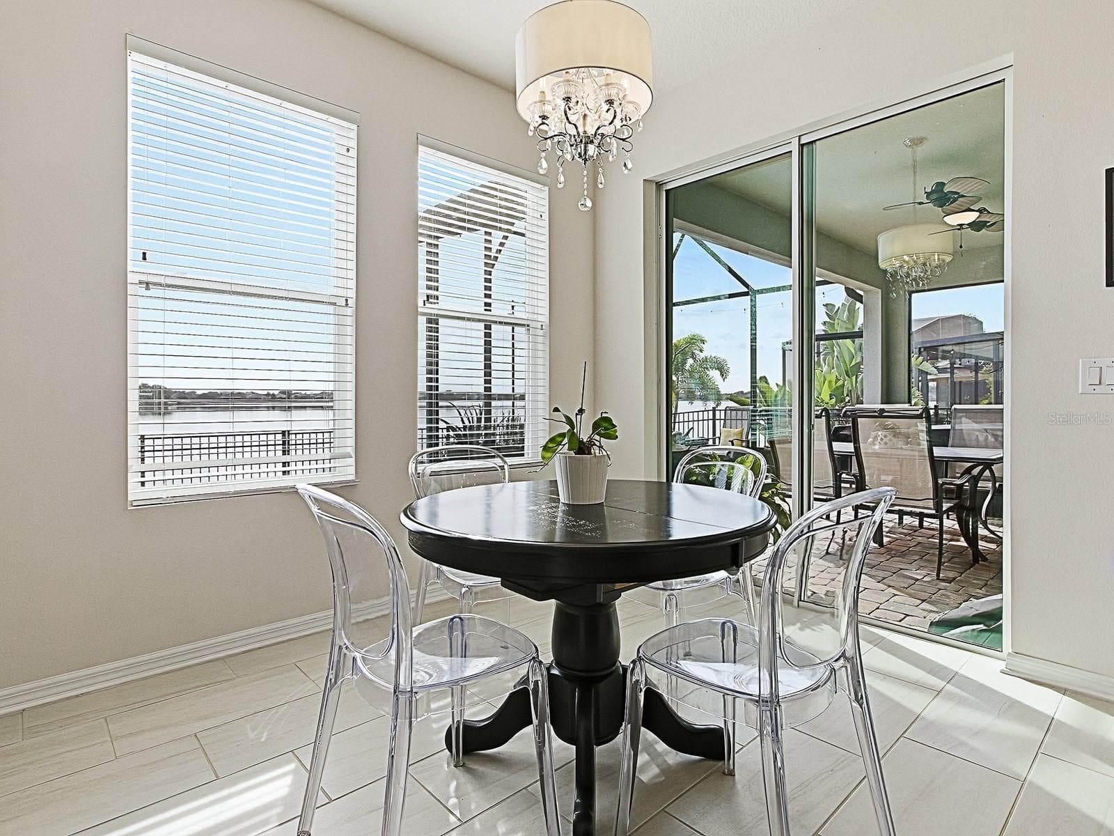 Dinette overlooking the extended porch with stunning lake views - 417 BLUE CYPRESS DR, GROVELAND