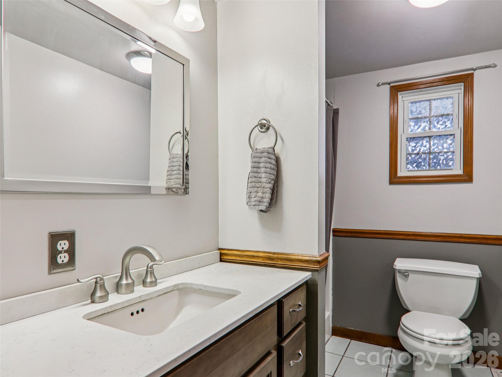 Primary ensuite bathroom with updated vanity, solid-surface countertop, and walk-in shower - 7 Landon Mountain Lane, Weaverville