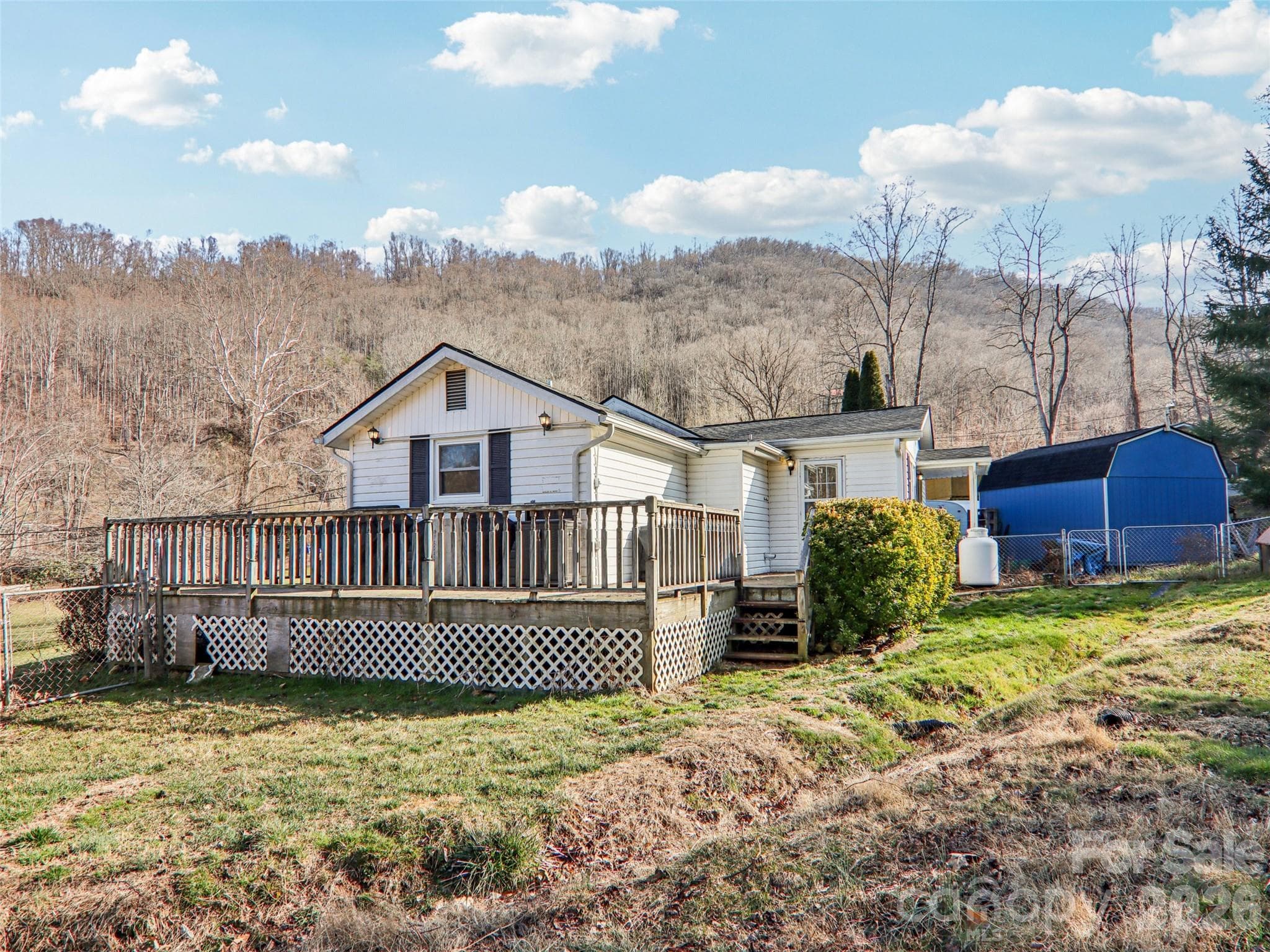 Alternate view of the rear and side of the home with storage shed - 7 Landon Mountain Lane, Weaverville