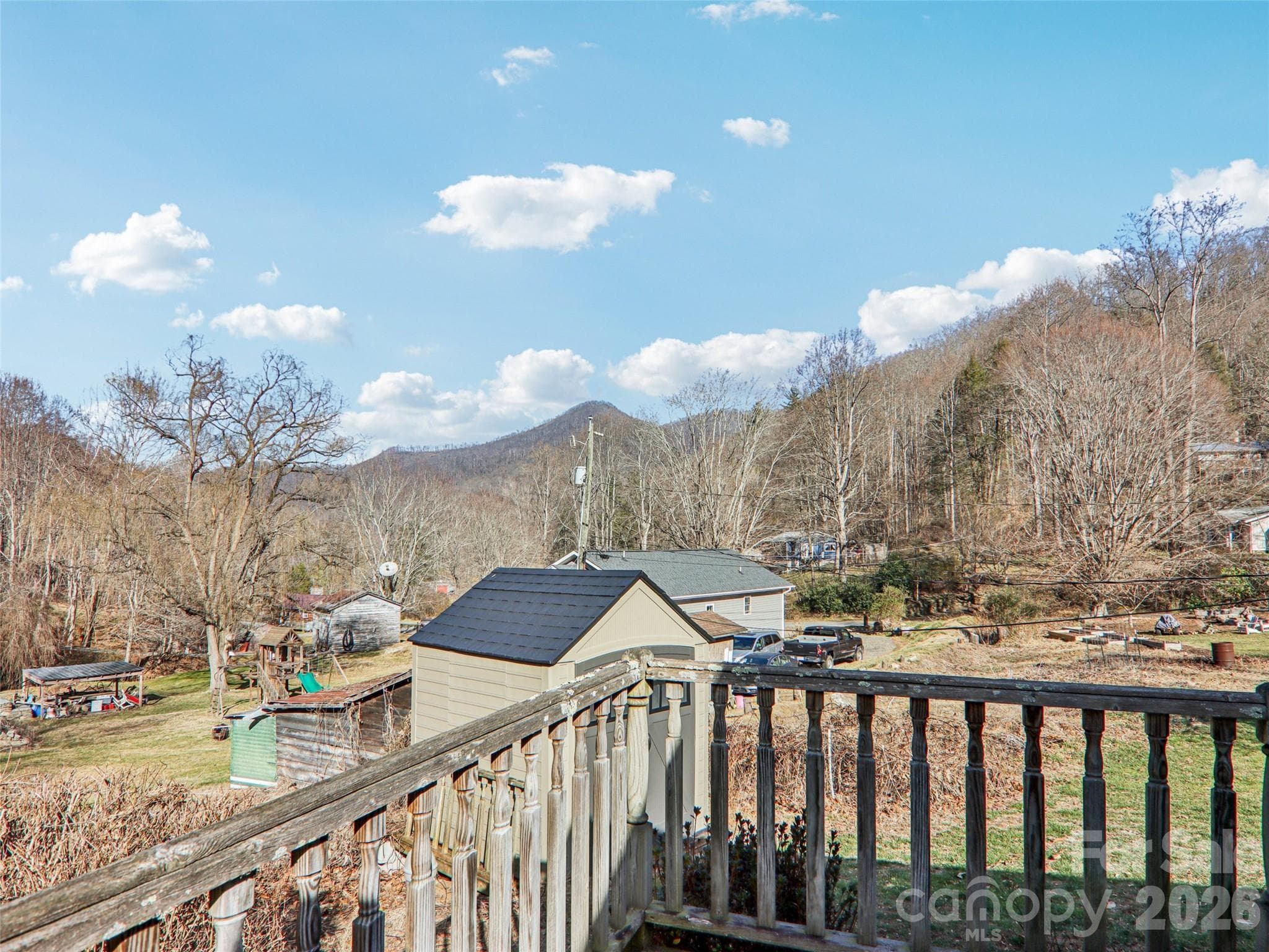 View of the front and side yard from the deck, with surrounding mountain landscape - 7 Landon Mountain Lane, Weaverville