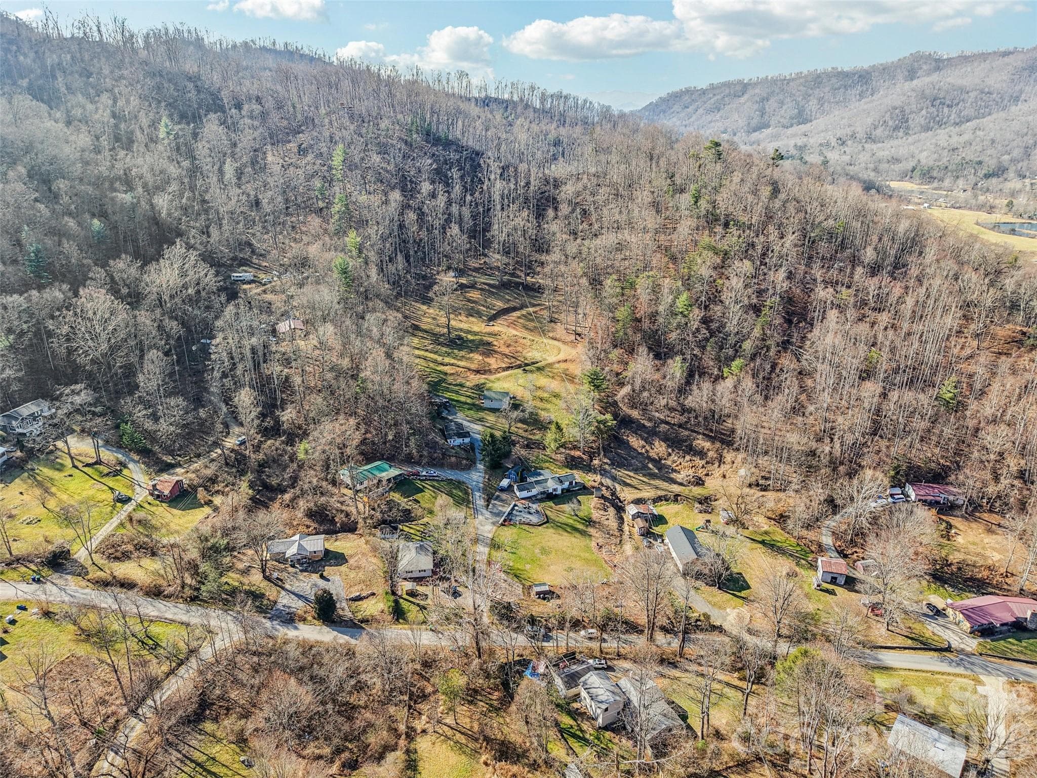 Aerial view of the property showing the surrounding neighborhood and mountain setting - 7 Landon Mountain Lane, Weaverville